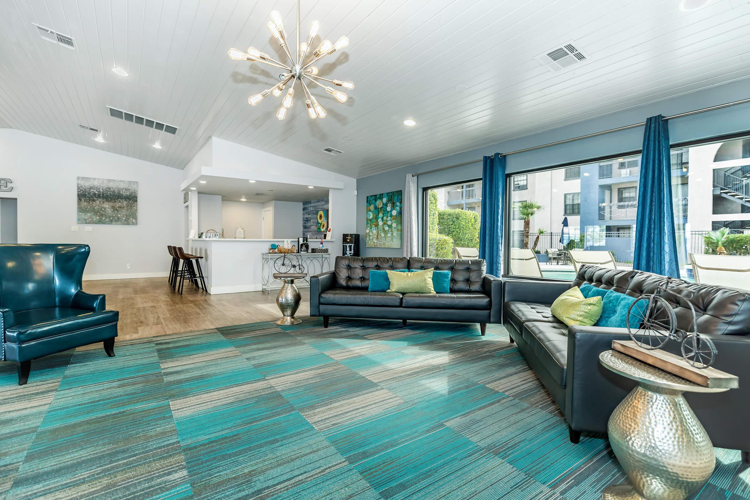 a living room filled with furniture and a large window