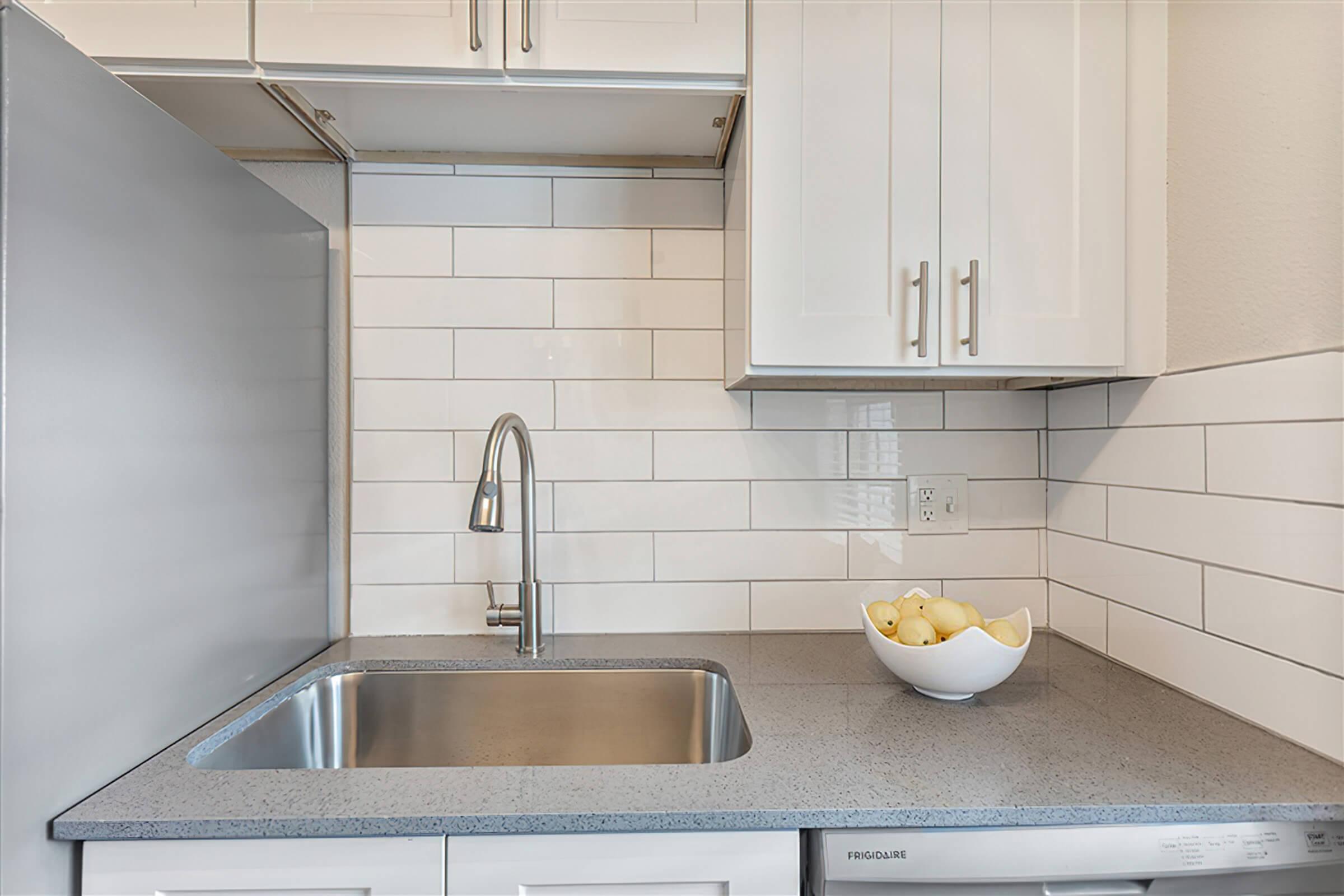 a kitchen with a sink and a mirror