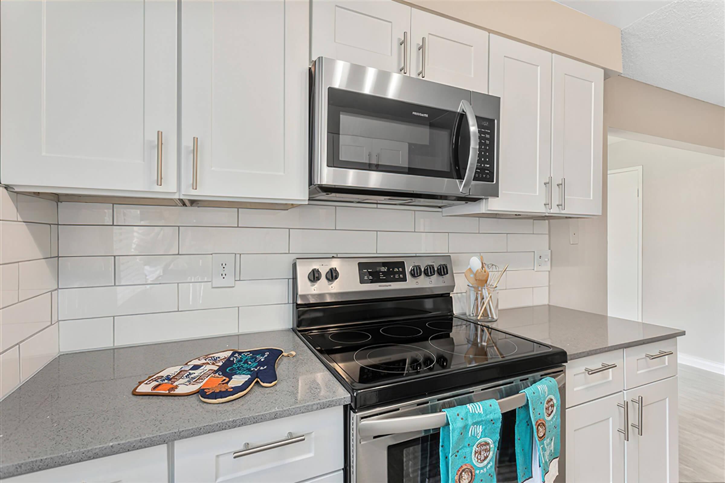 a stove top oven sitting inside of a kitchen