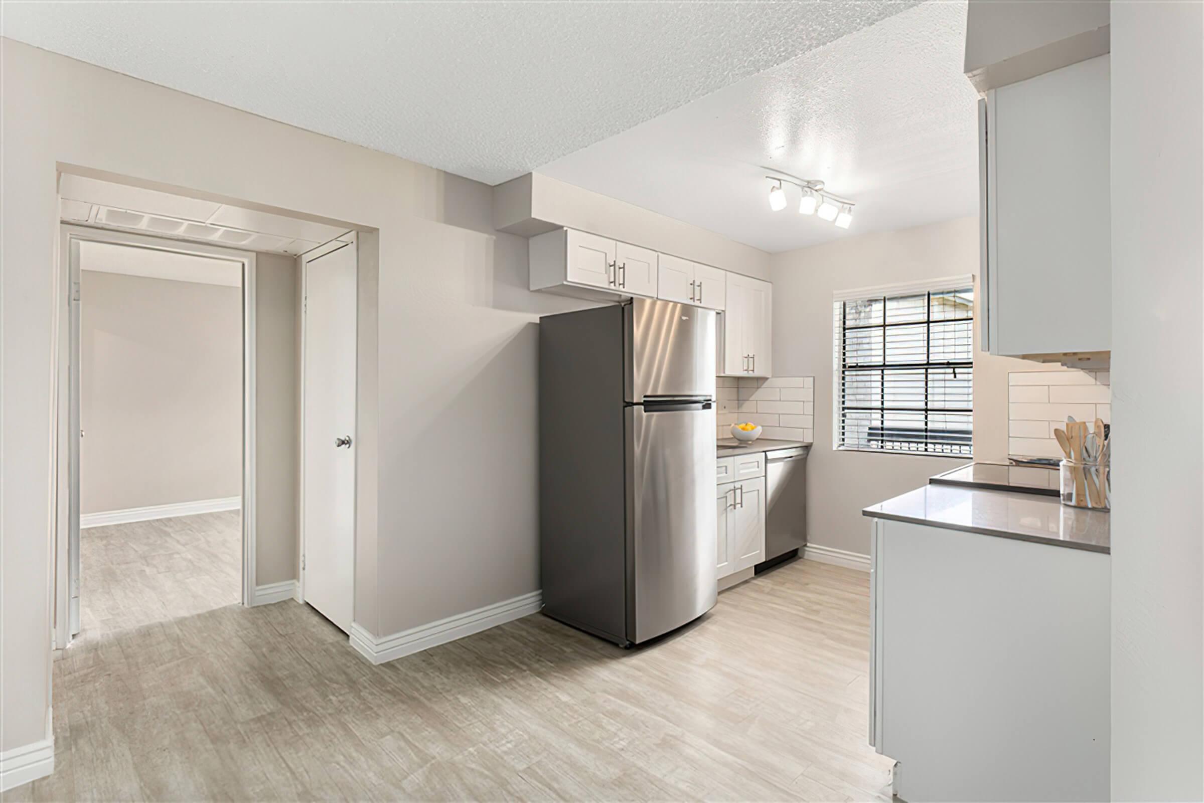 a kitchen with a sink and a refrigerator