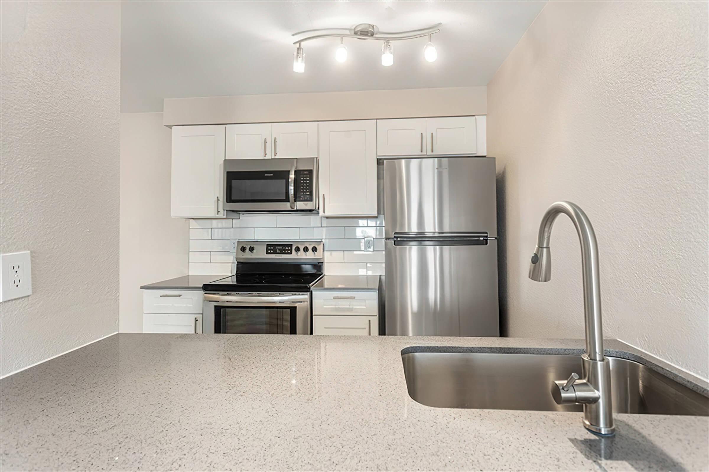 a kitchen with a sink and a mirror