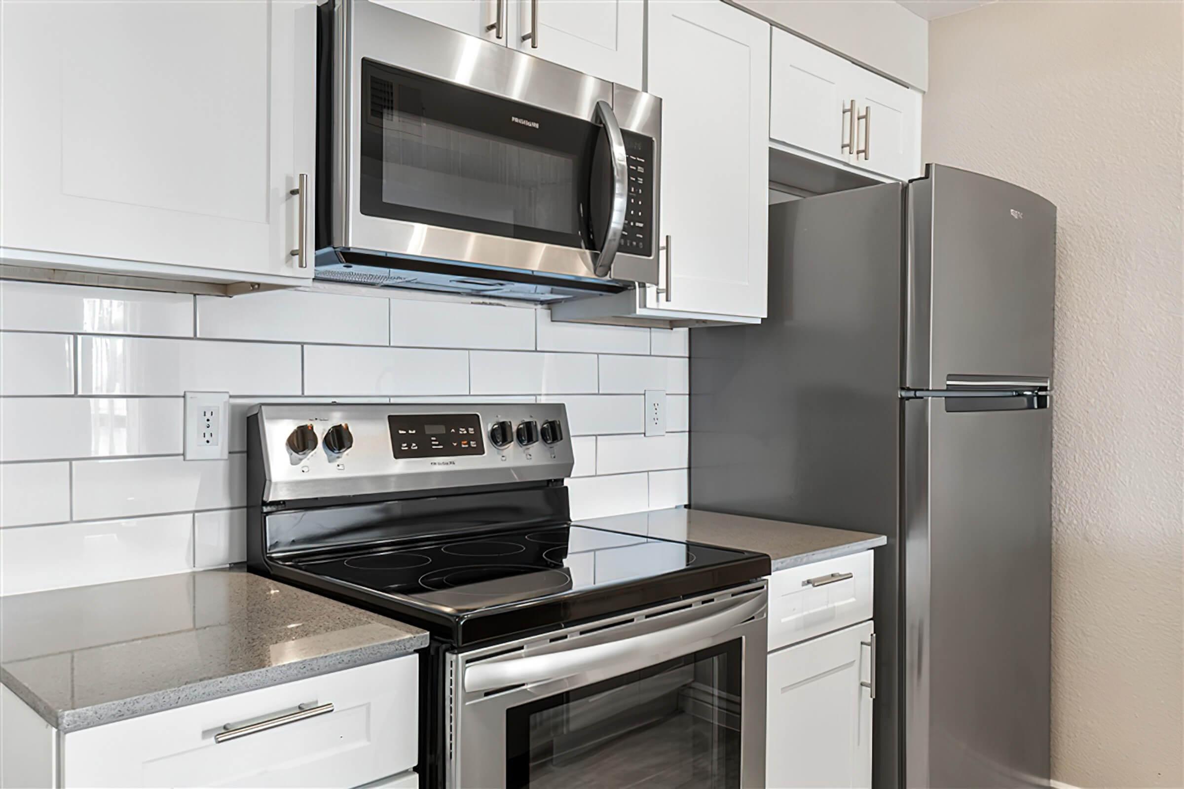 a stove top oven sitting inside of a kitchen