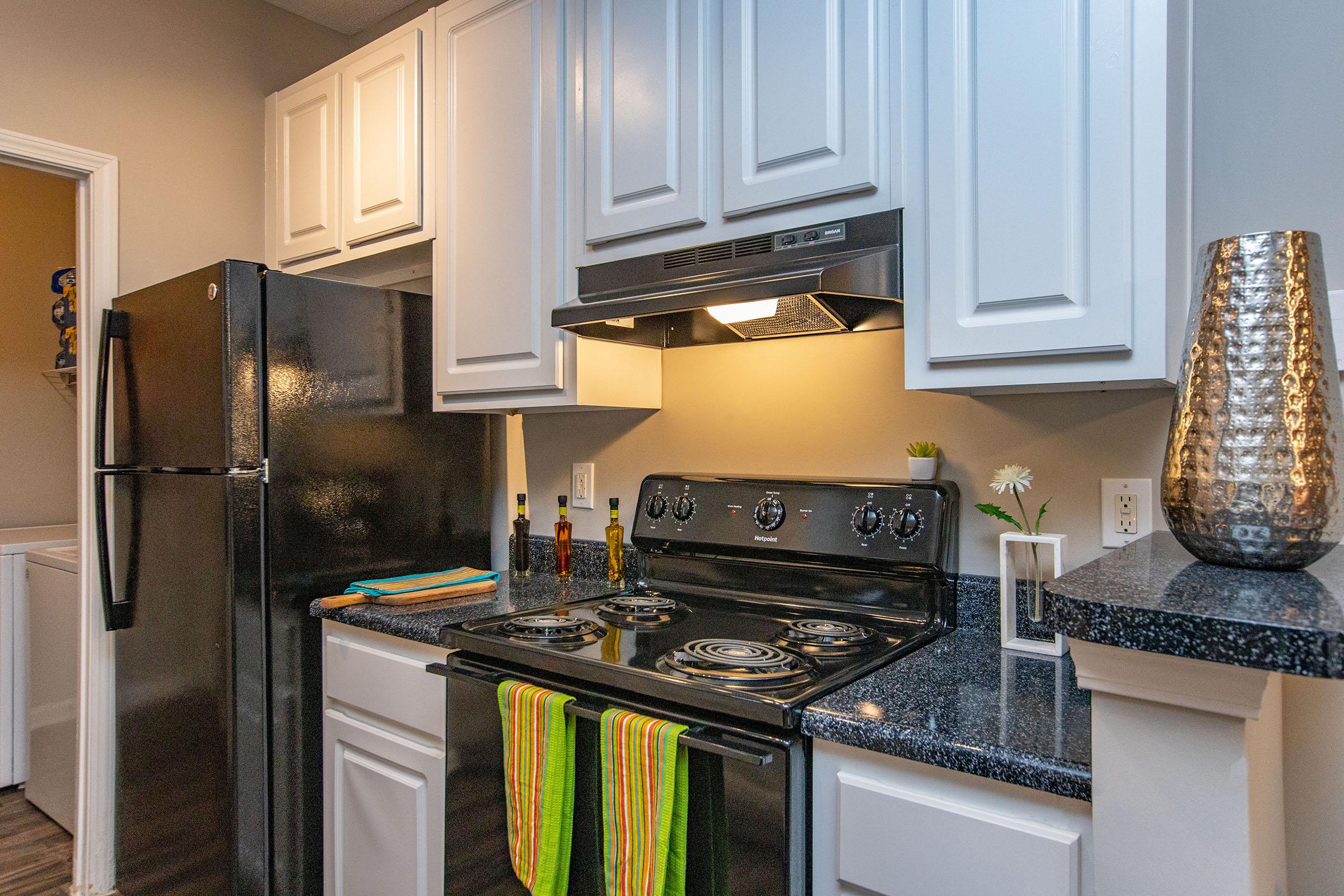 a stove top oven sitting inside of a kitchen