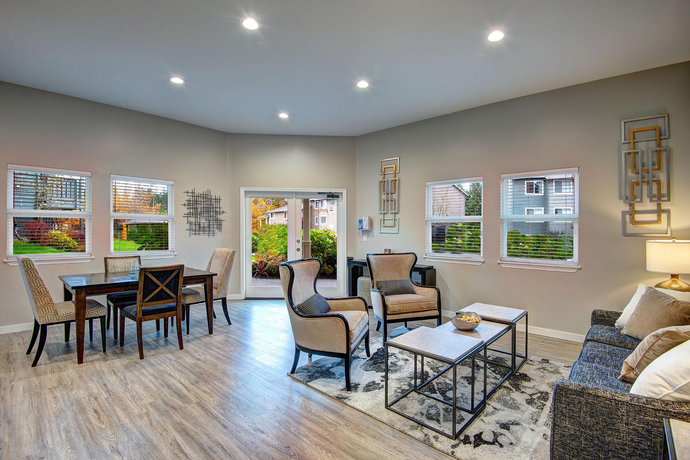 a living room filled with furniture and a large window