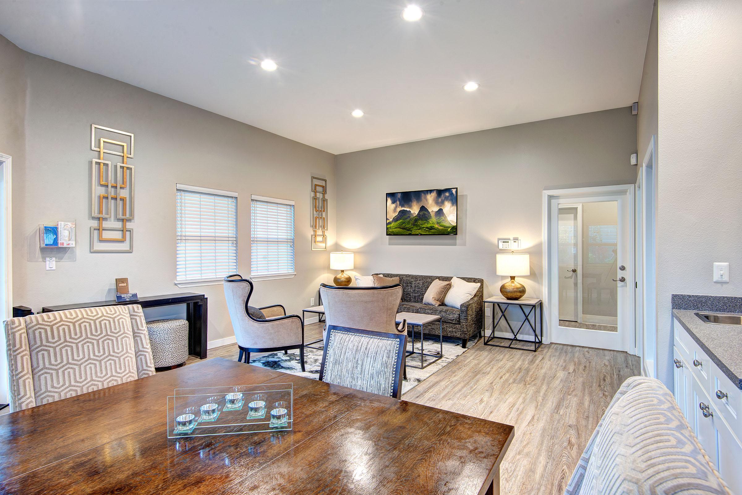 a living room filled with furniture and a large window