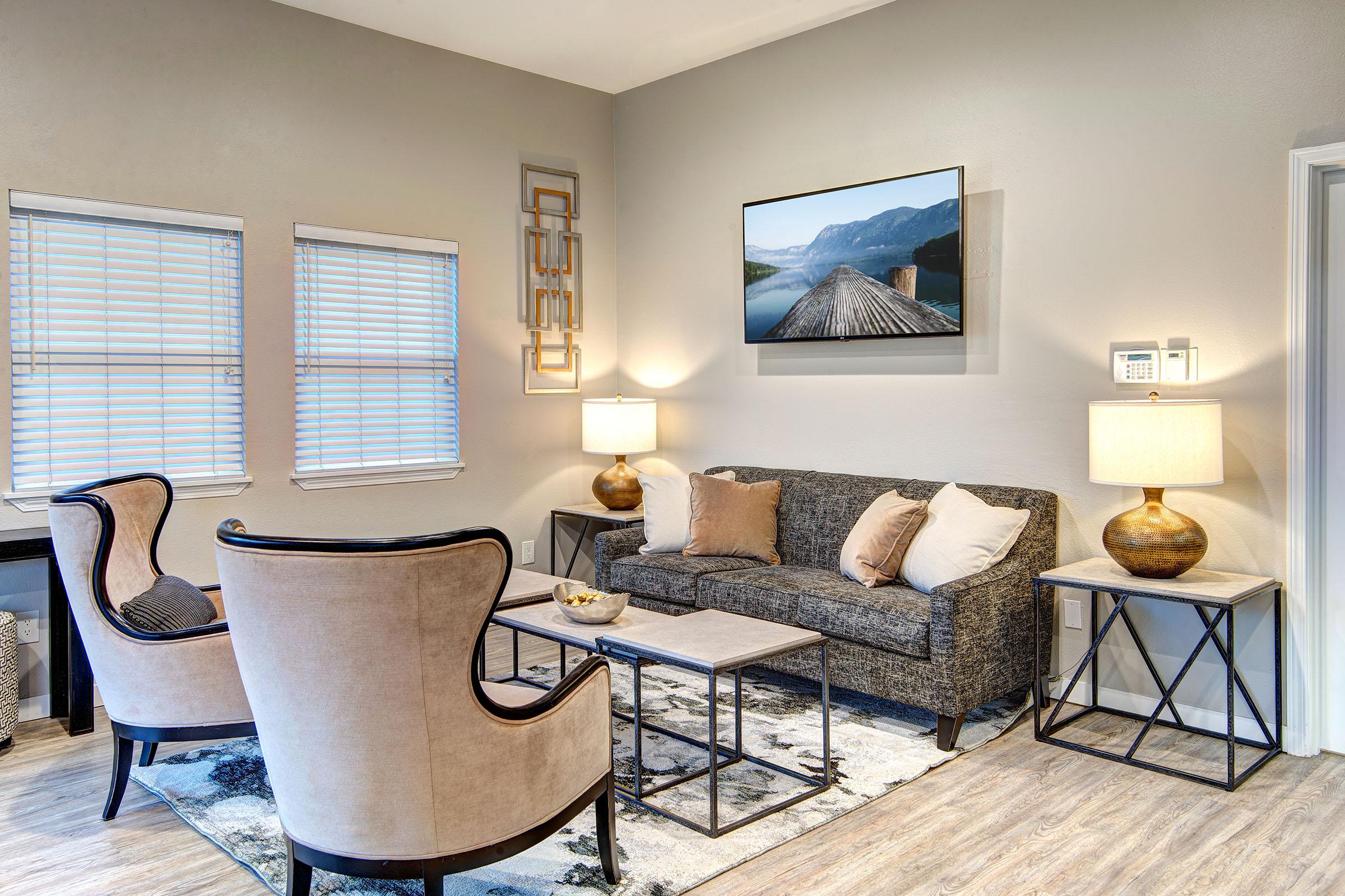 a living room filled with furniture and a large window