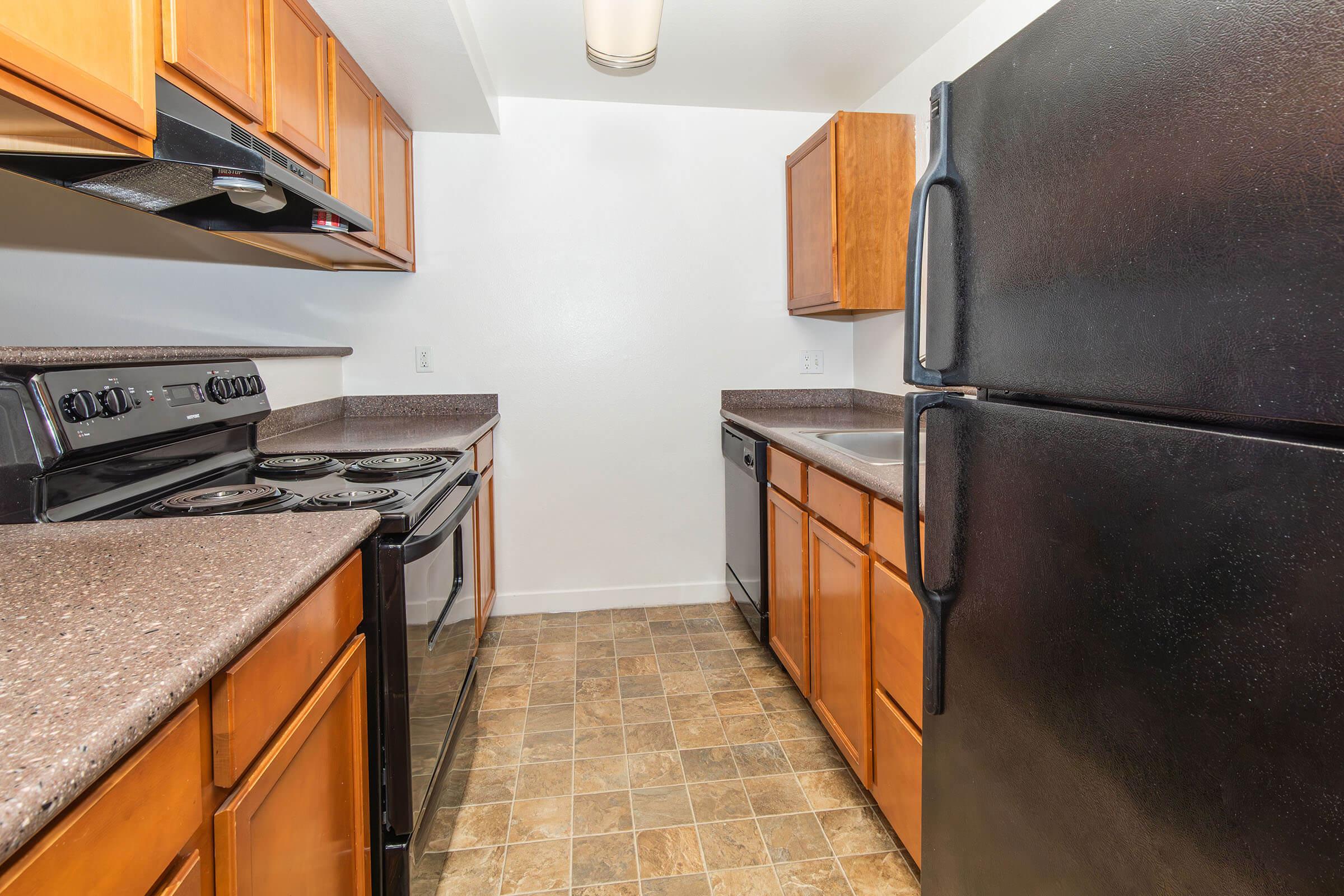 a kitchen with a stove and a refrigerator