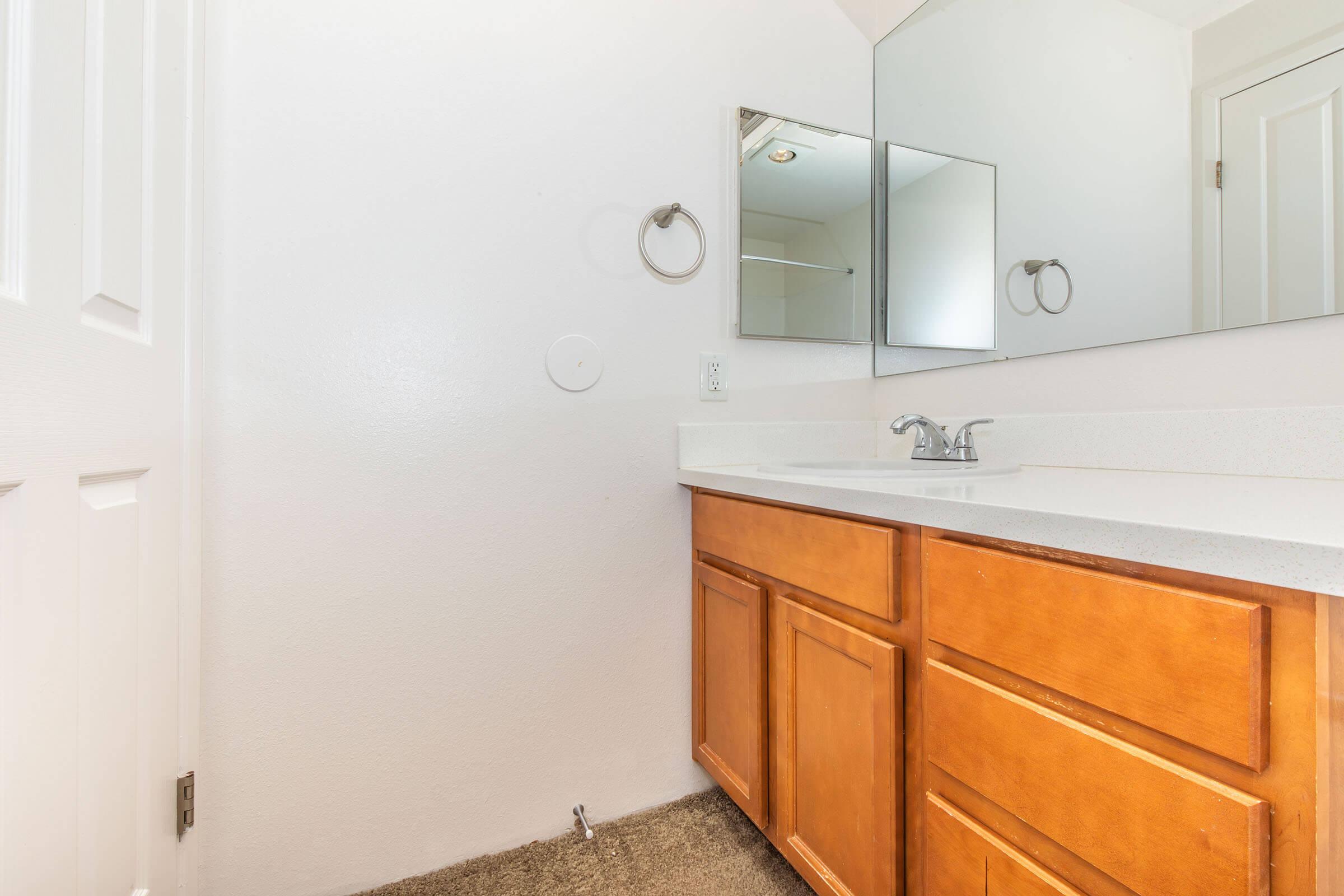 a kitchen with a sink and a mirror