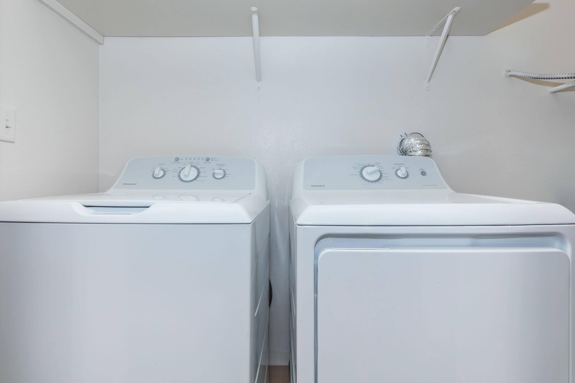 a microwave oven sitting on top of a refrigerator