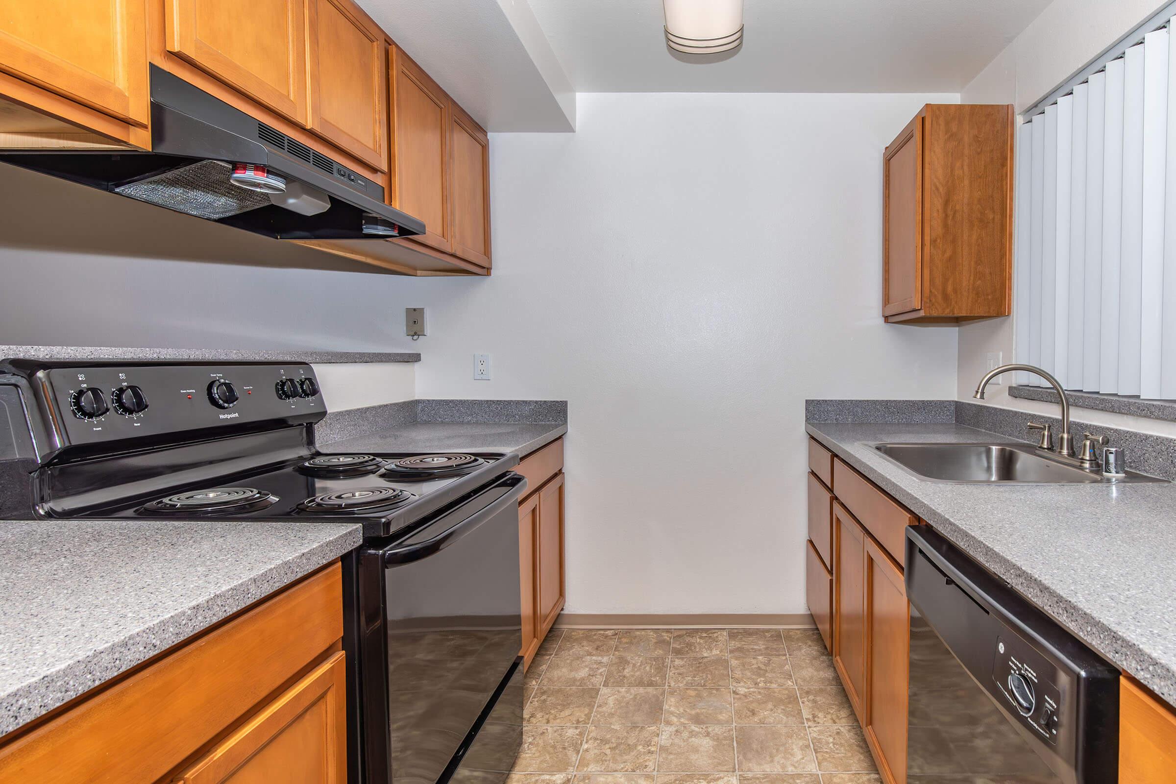 a modern kitchen with stainless steel appliances and wooden cabinets