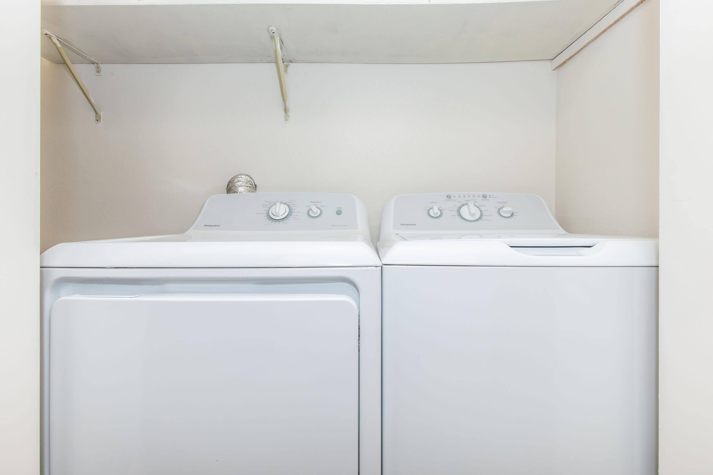 a microwave oven sitting on top of a refrigerator