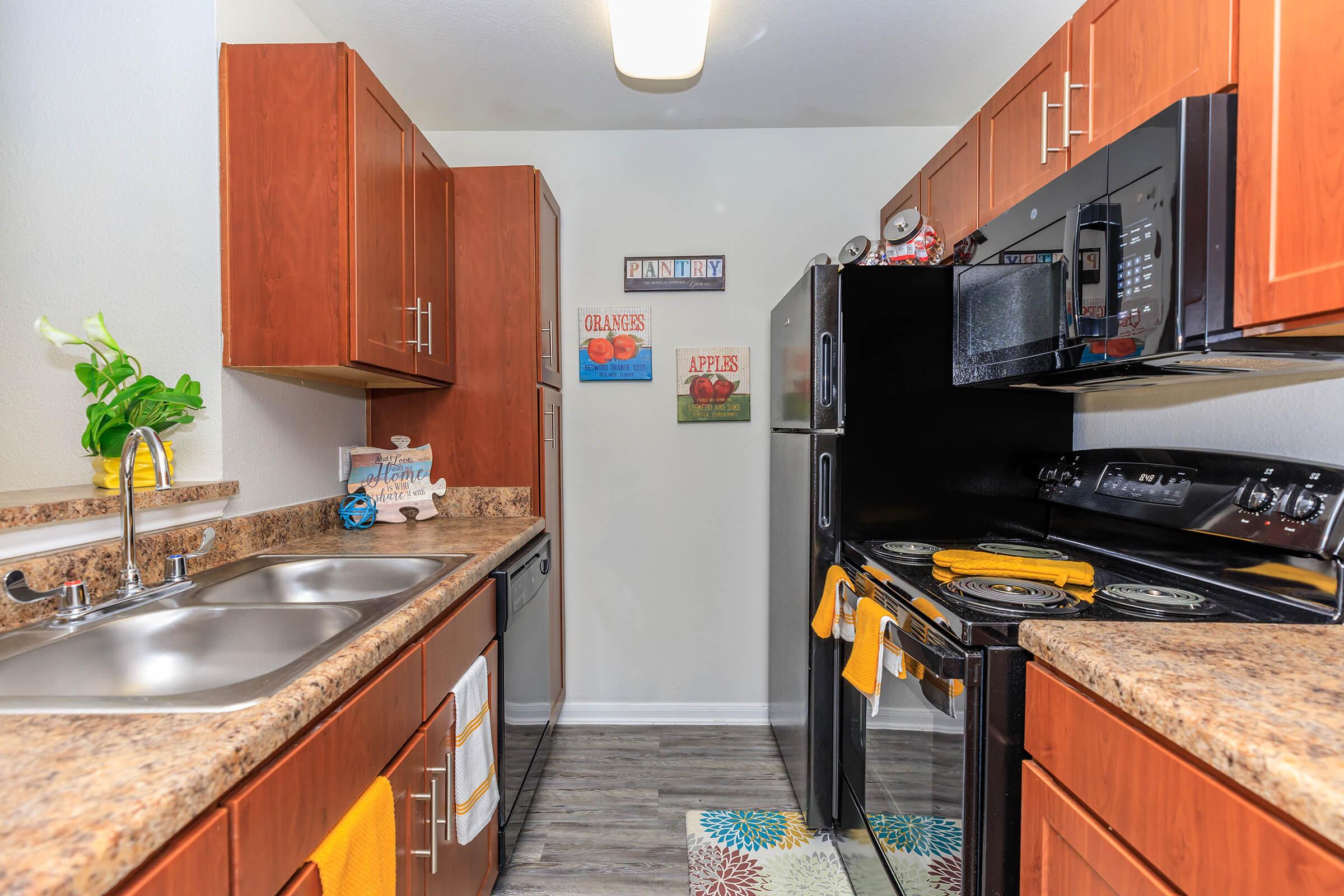 a modern kitchen with stainless steel appliances and wooden cabinets