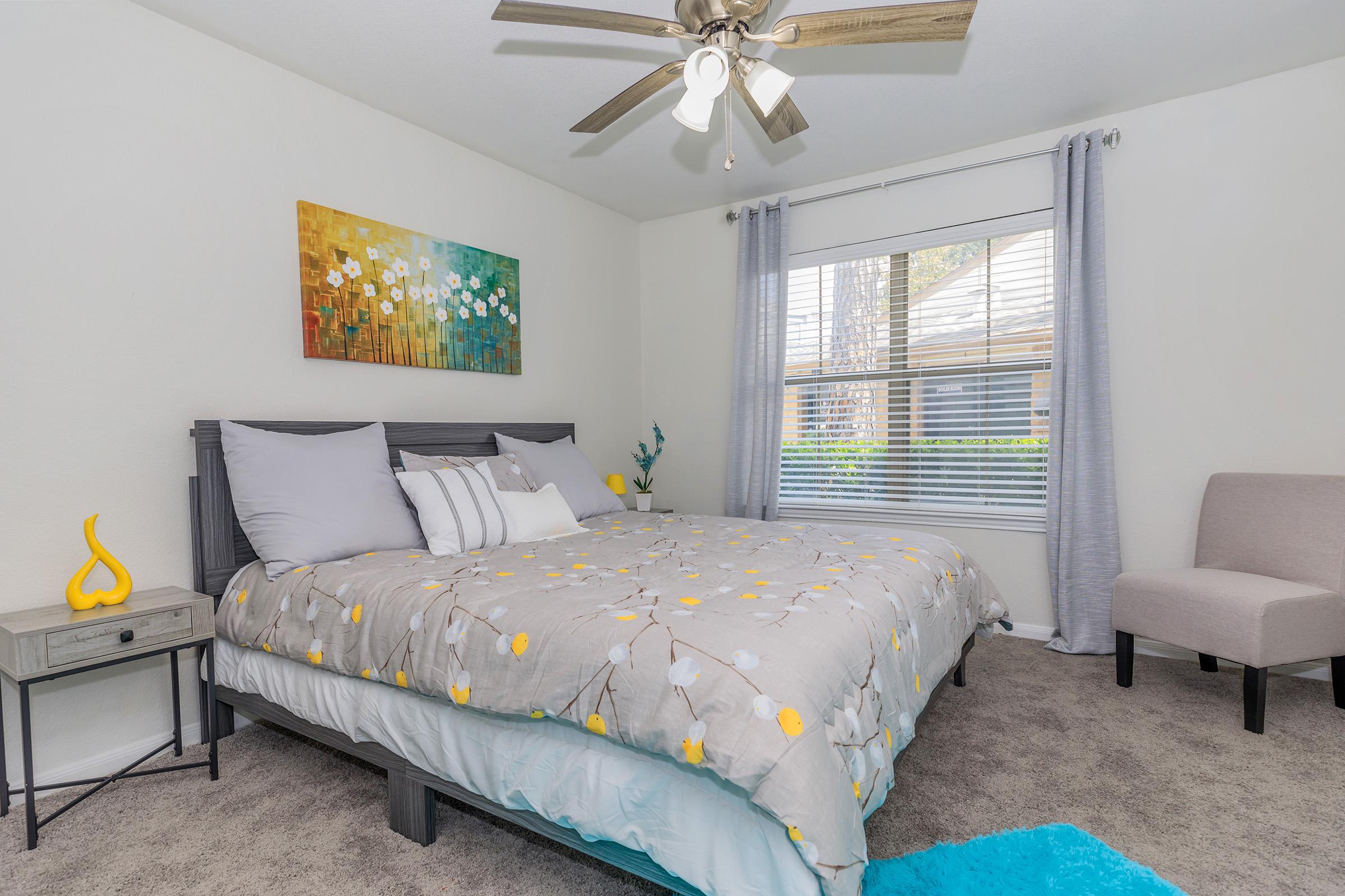 a bedroom with a bed and desk in a room