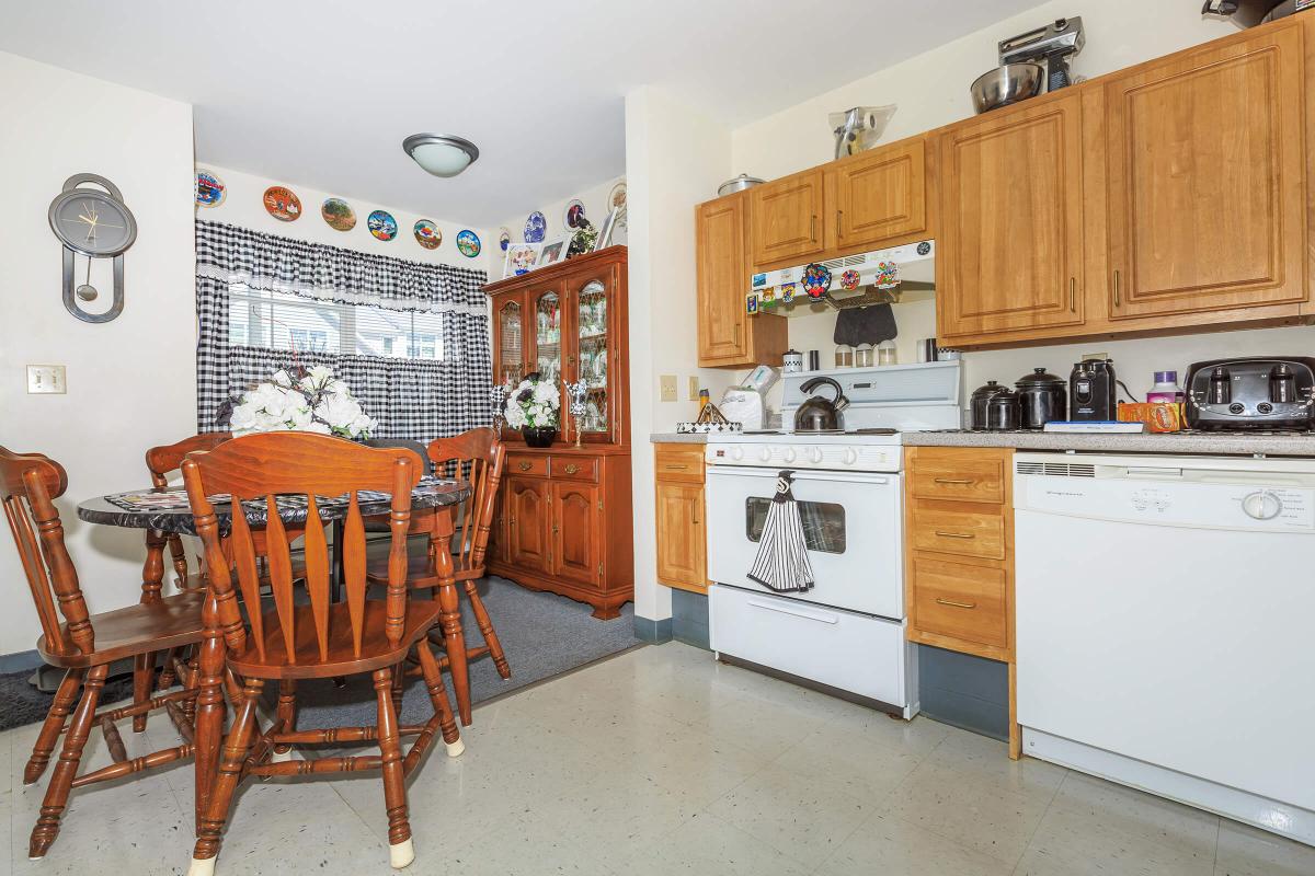 a kitchen with wooden cabinets and a dining table