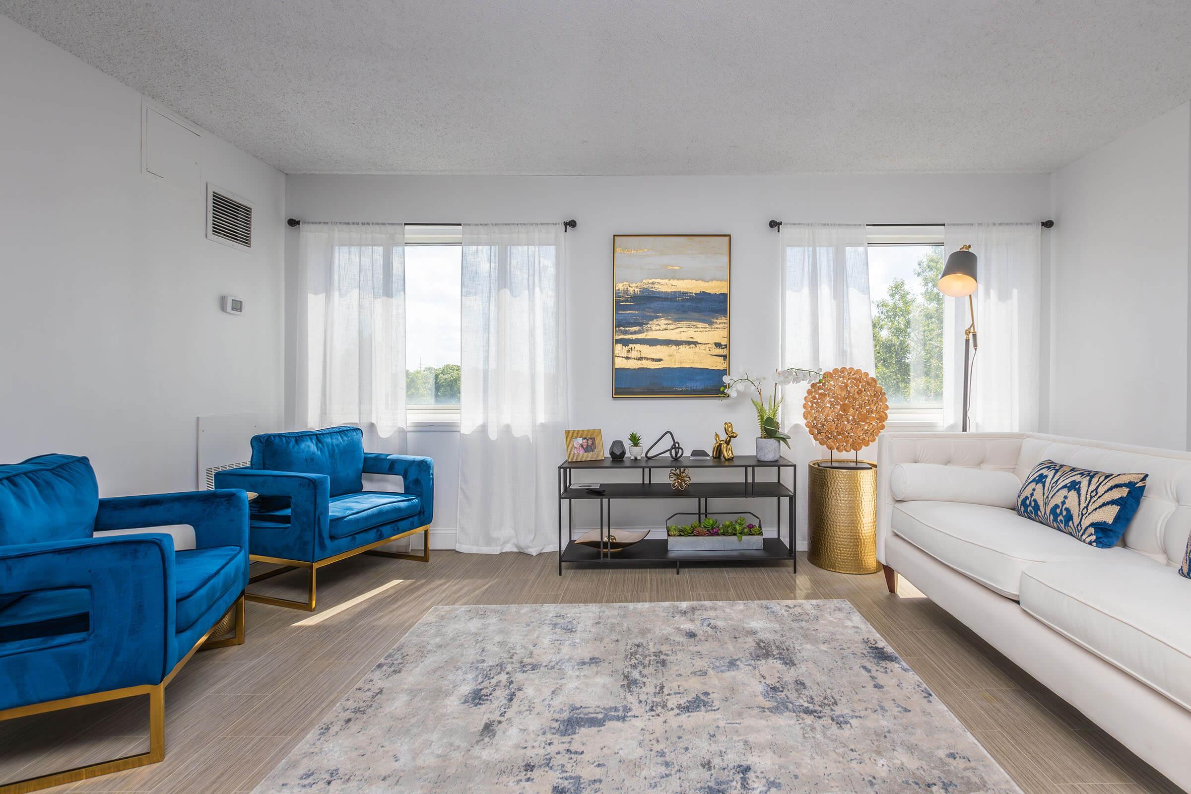 a living room filled with furniture and a large window