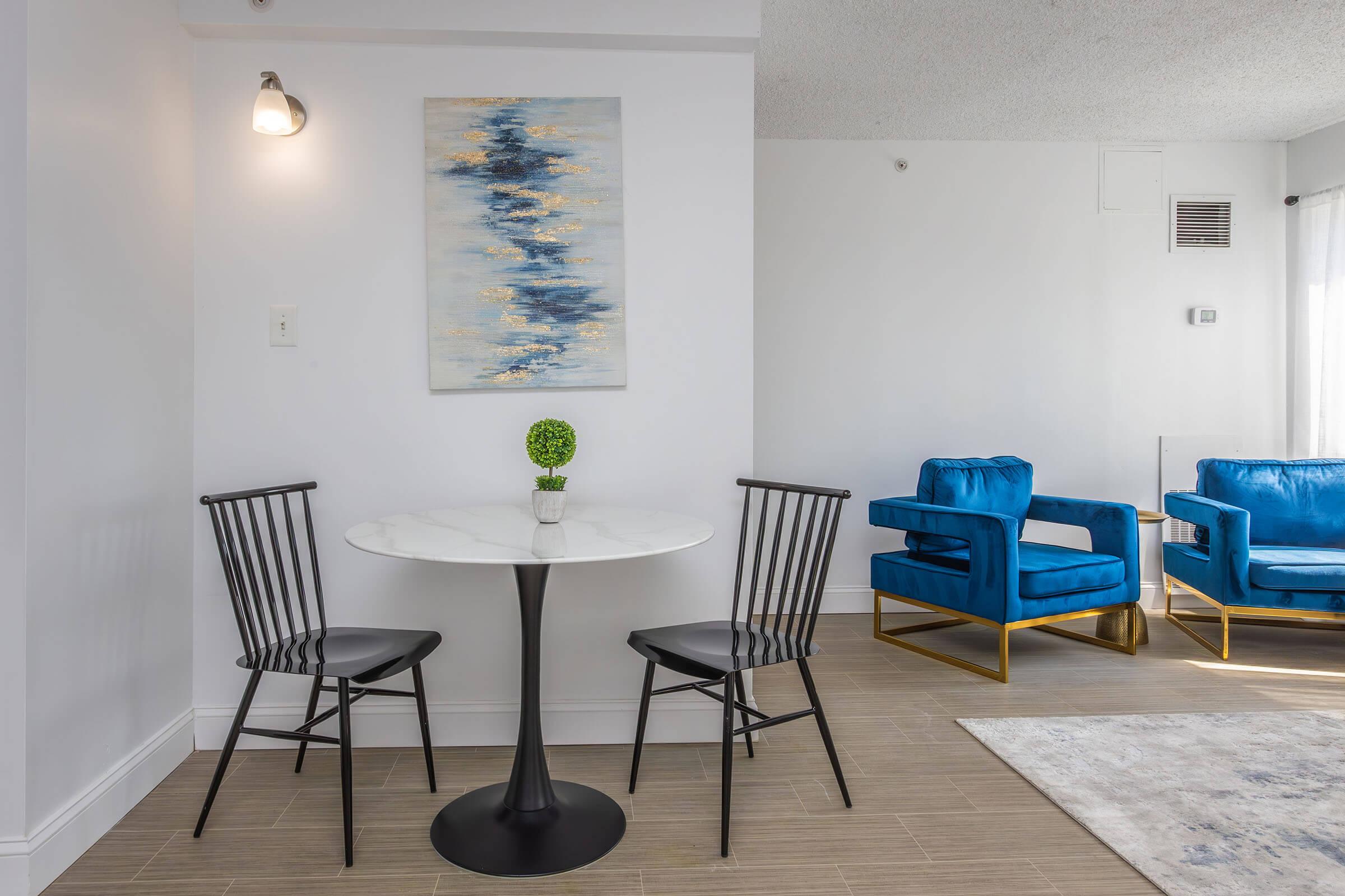 a living room filled with furniture and a blue chair