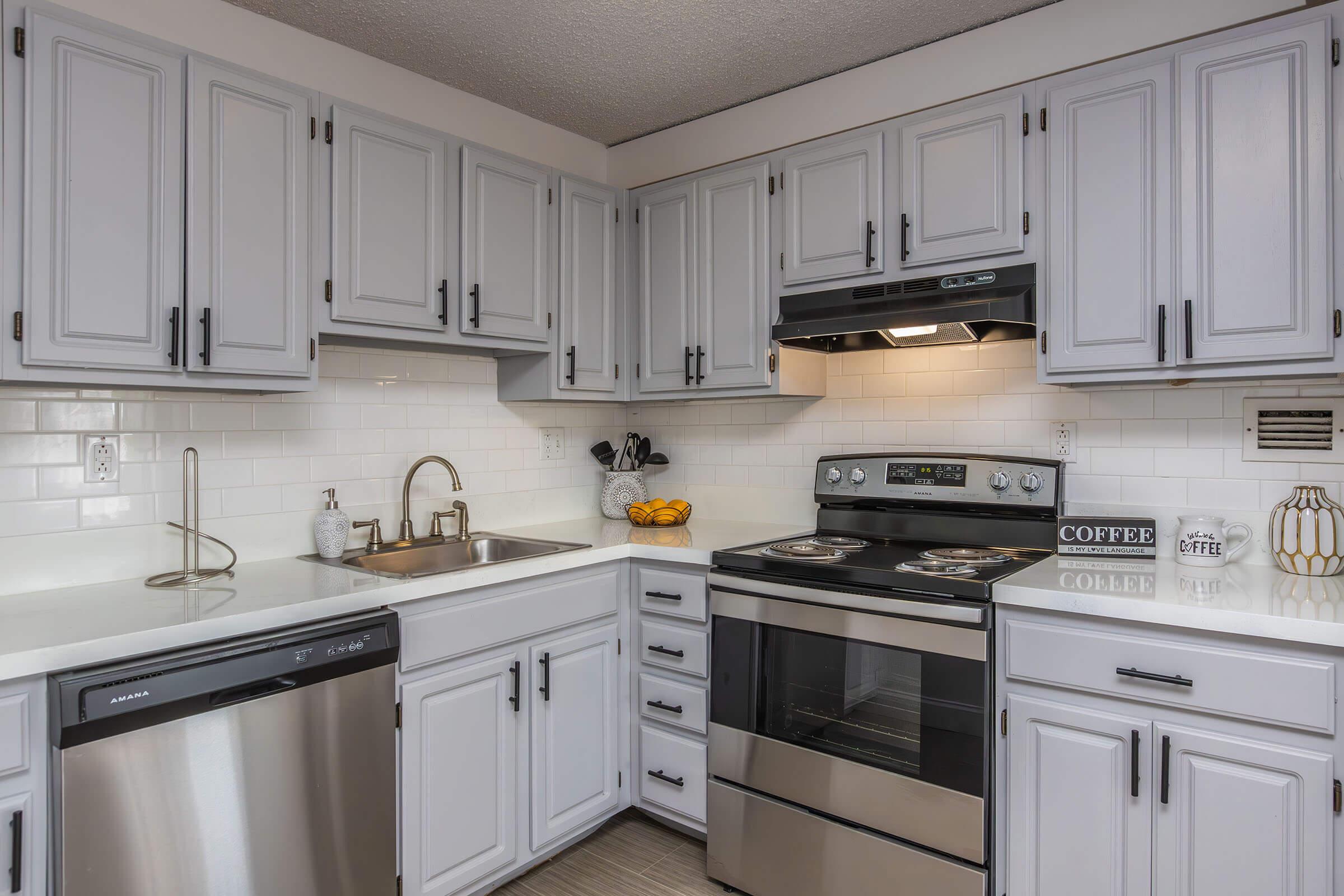 a kitchen with a stove a sink and a microwave