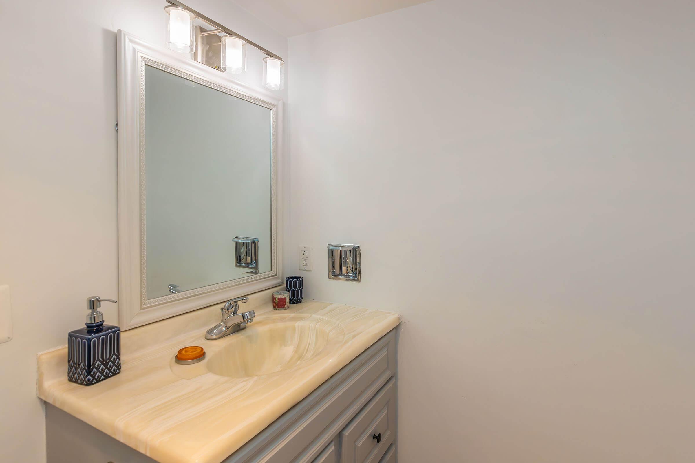 a kitchen with a sink and a mirror