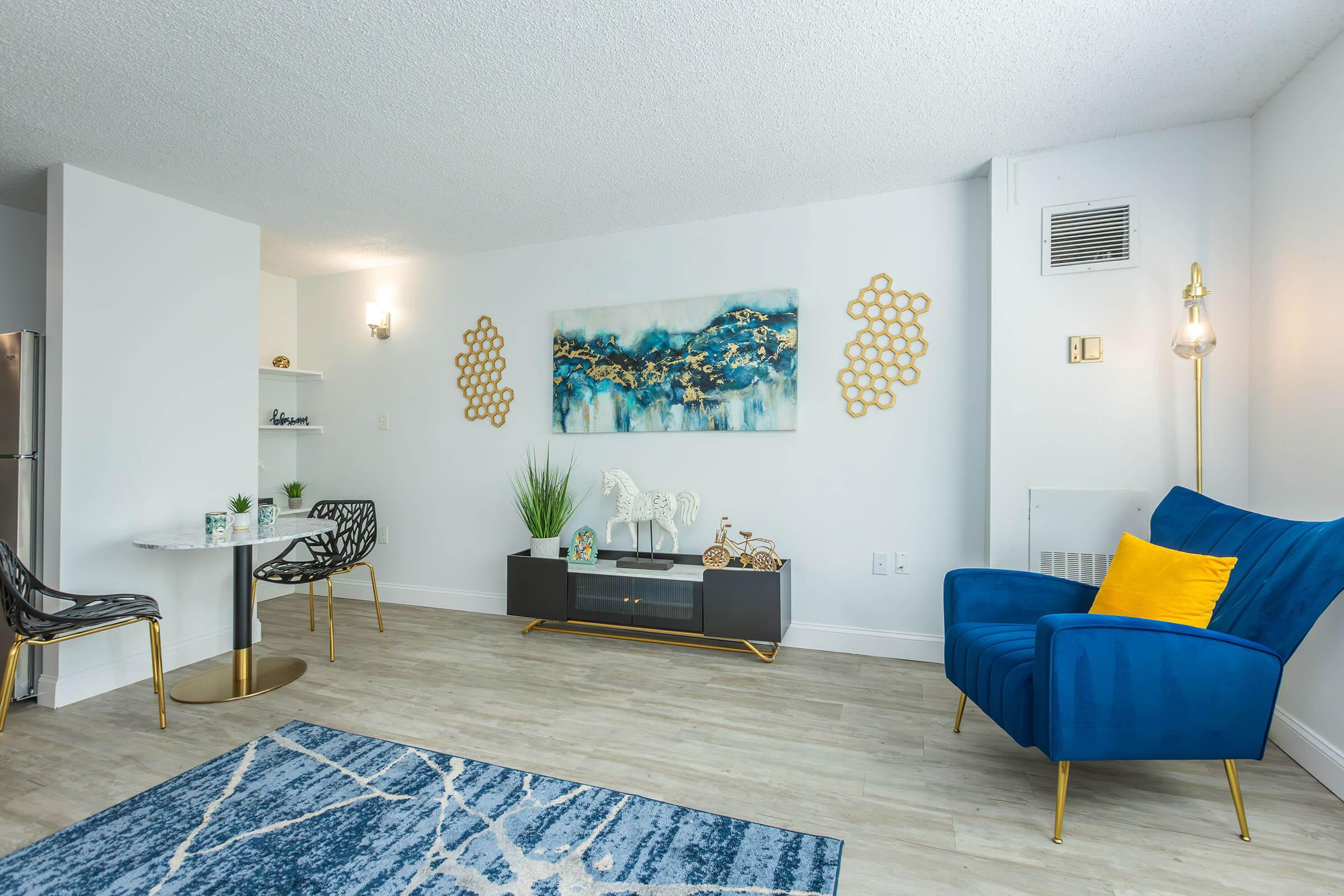 a living room filled with furniture and a bed in a bedroom