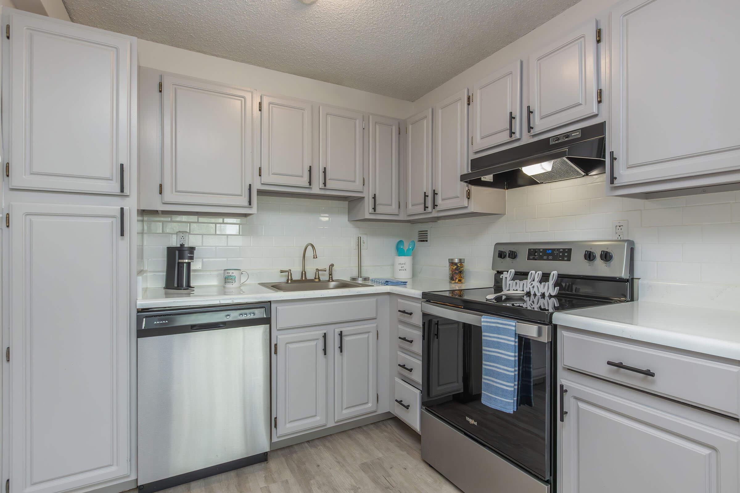 a kitchen with a stove sink and refrigerator