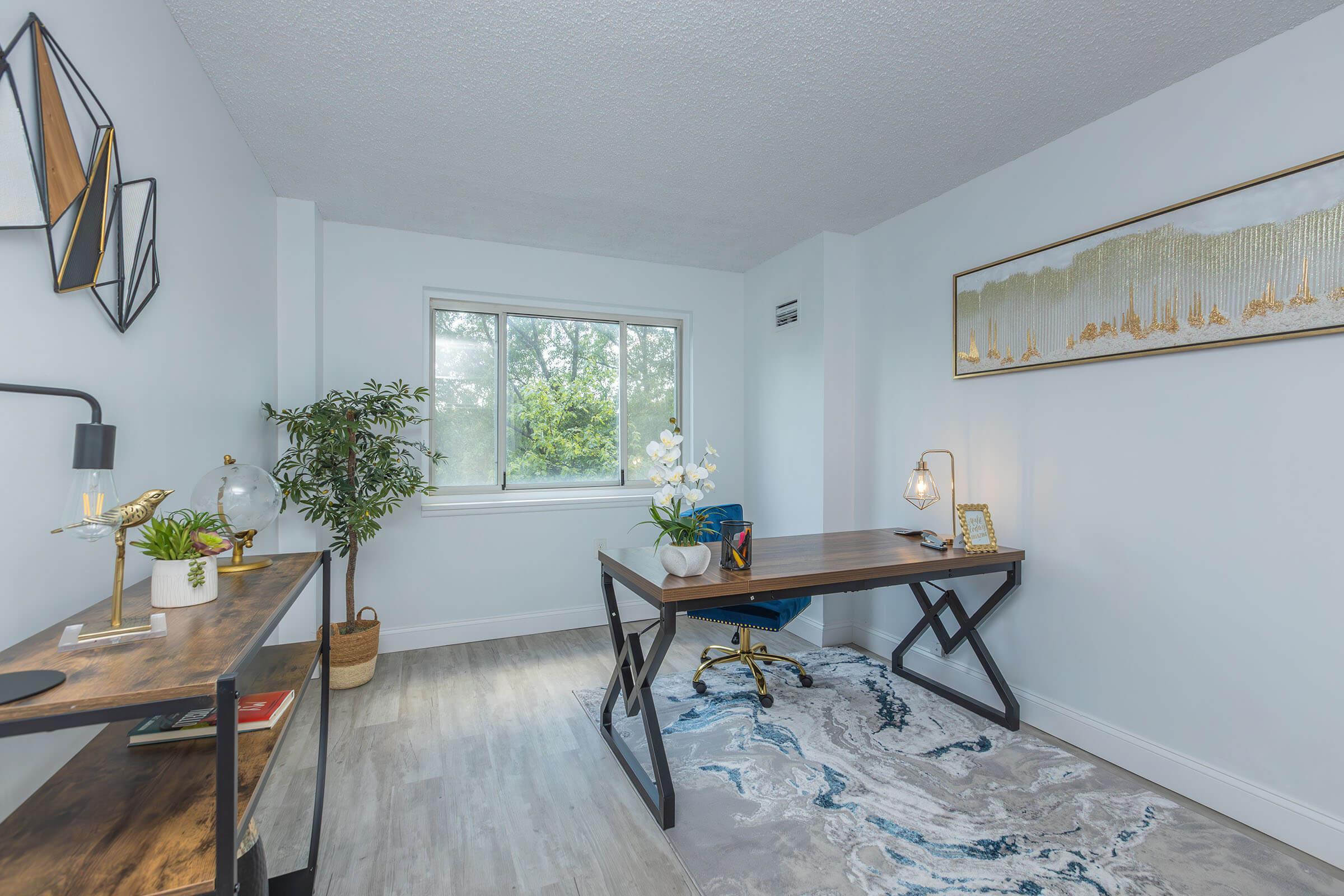 a living room filled with furniture and a large window