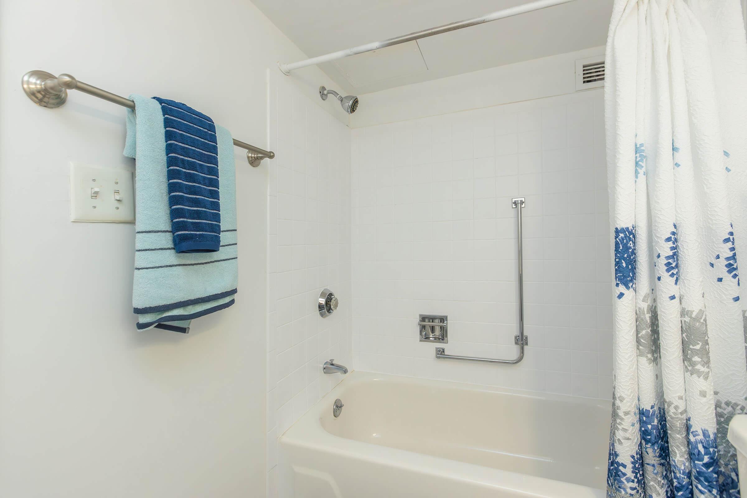 a shower curtain next to a sink