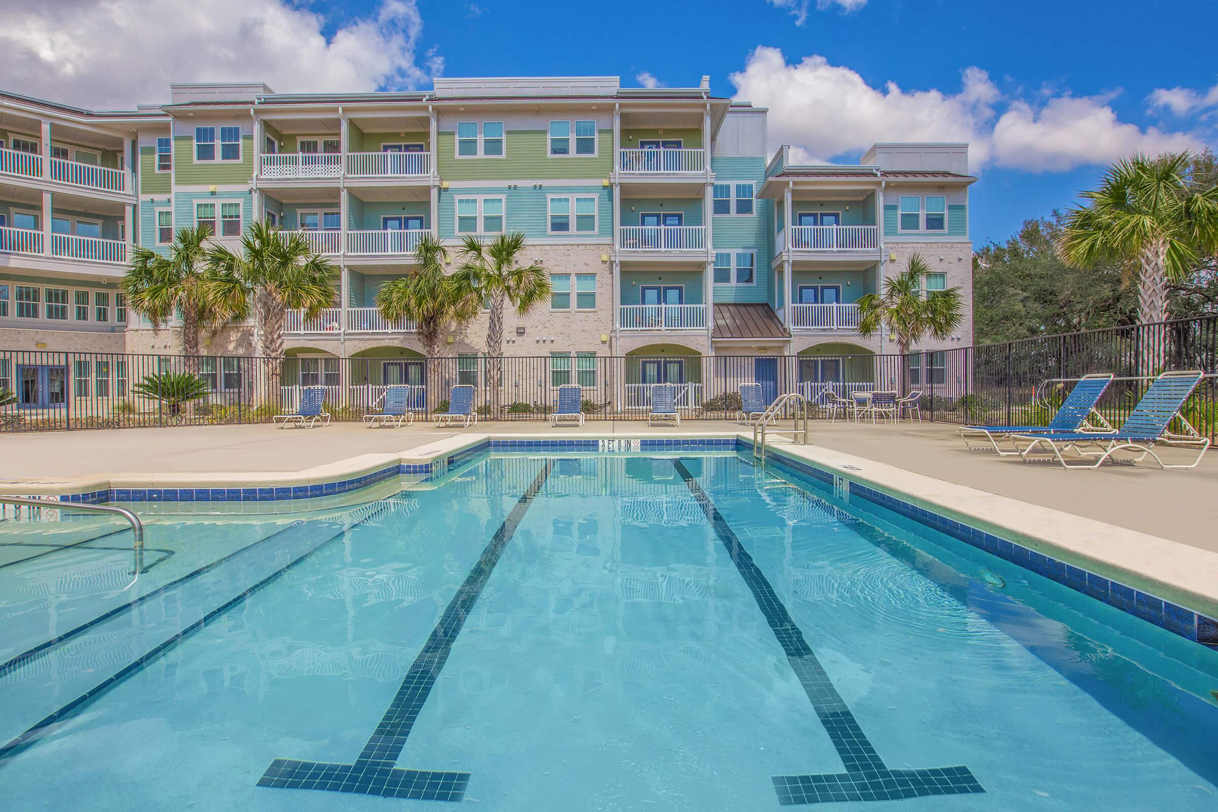 a person in a pool of water in front of a building