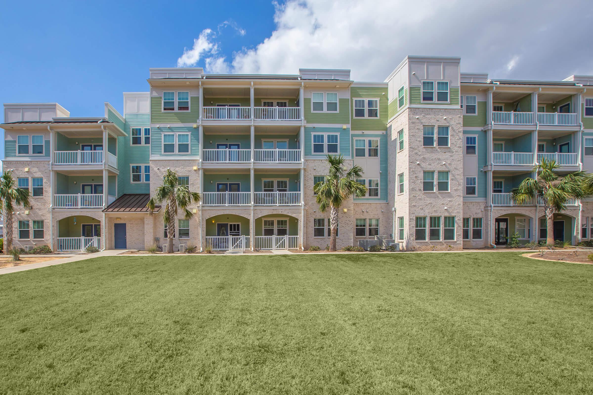 a large building with a grassy field