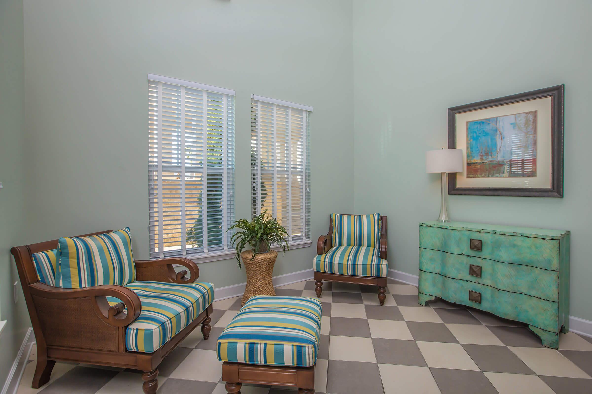 a living room filled with furniture and a window