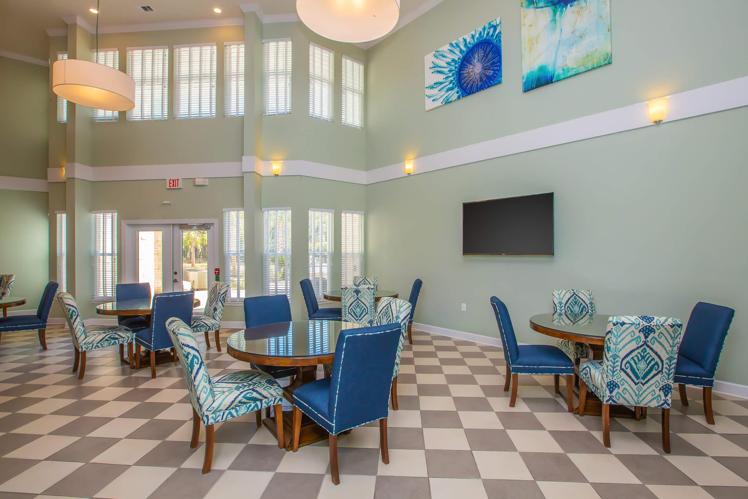 a living room filled with furniture and a blue chair