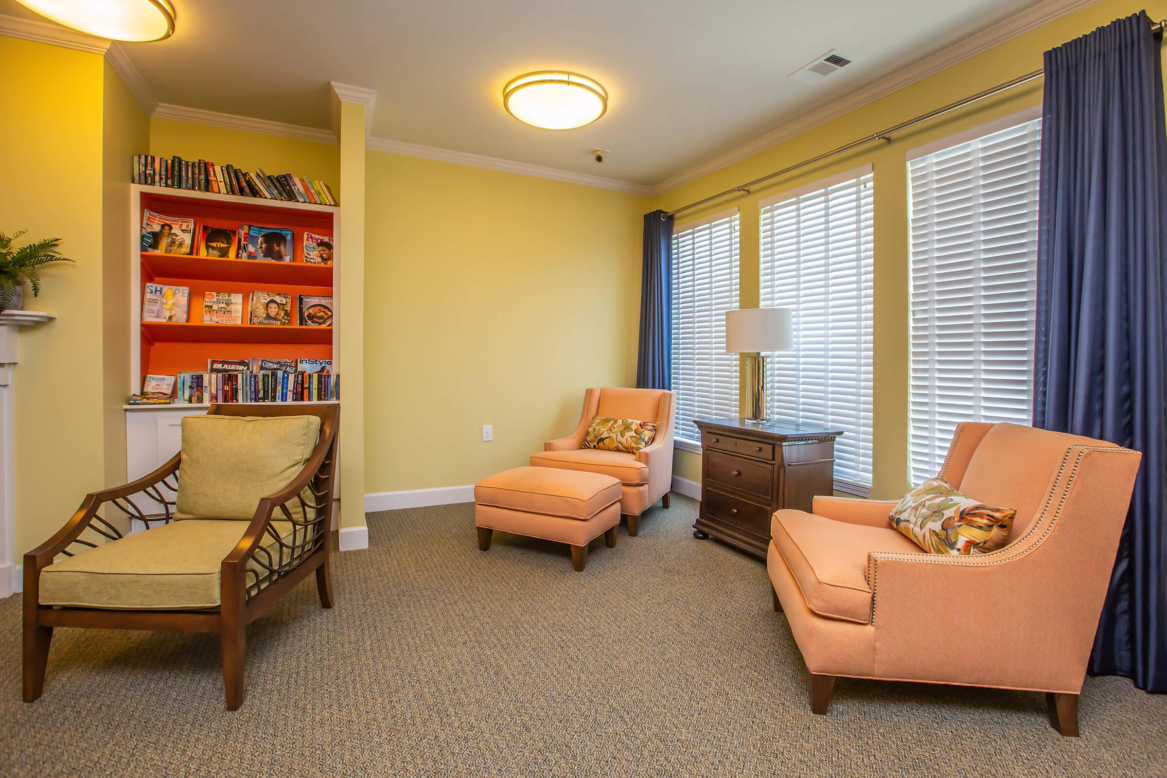 a living room filled with furniture and a large window