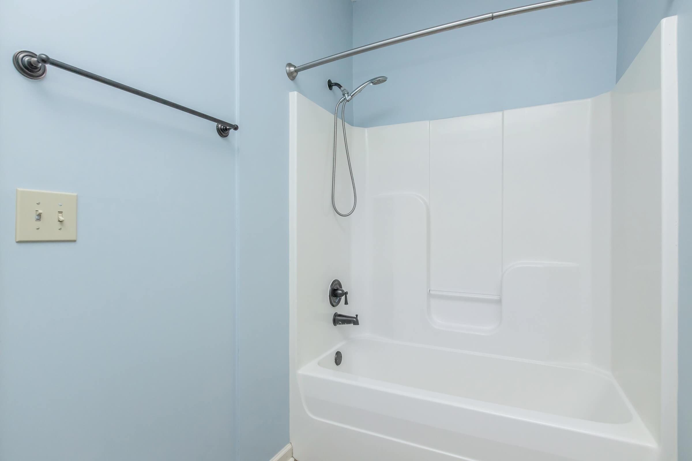 Tub and shower with towel rod