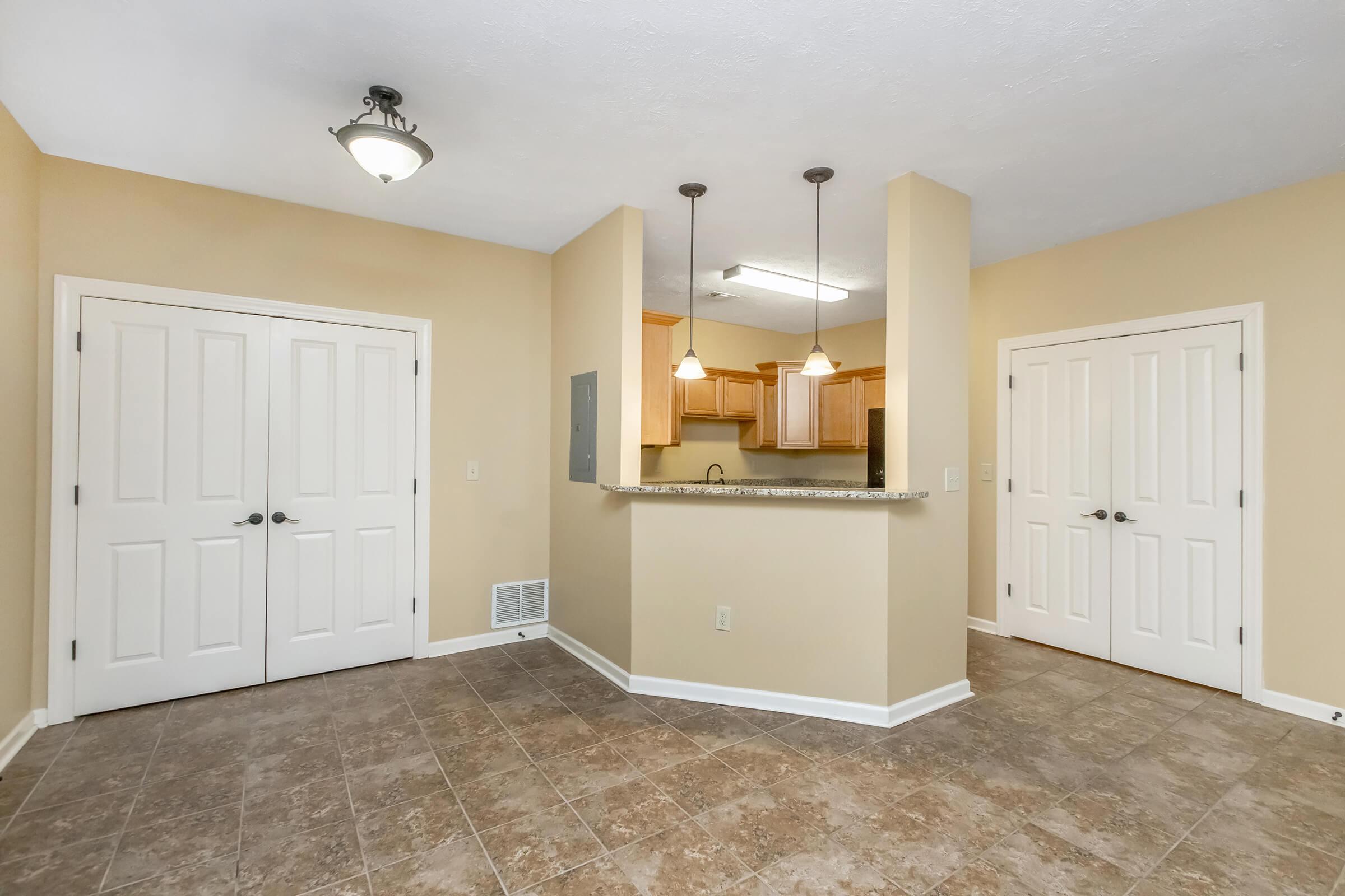 View of breakfast bar towards laundry room and pantry doors