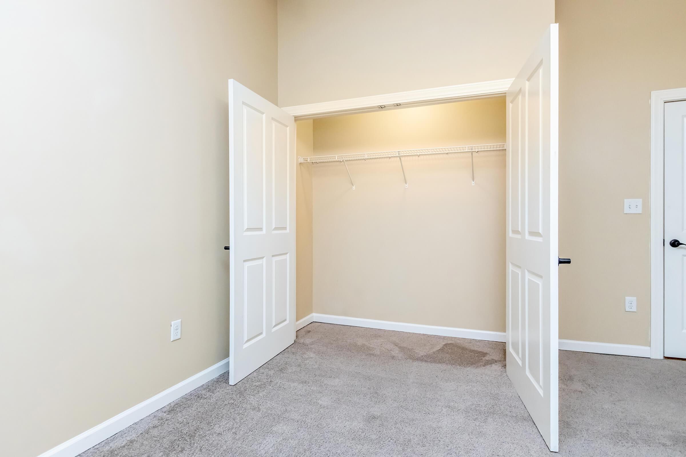 Large closet with double doors and shelving