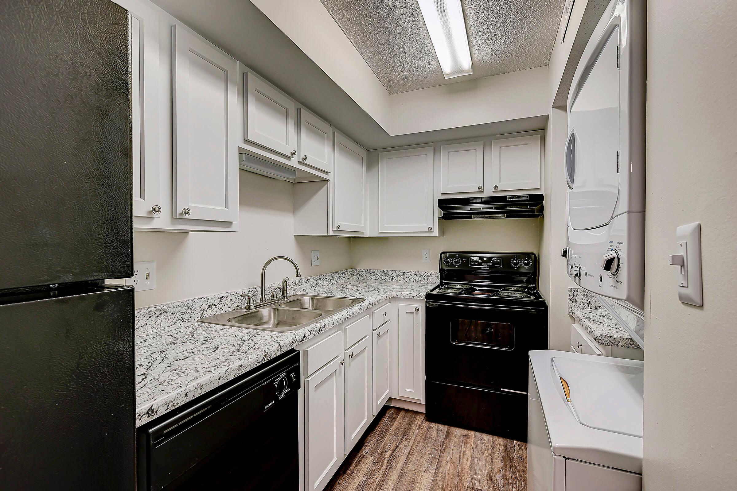 a kitchen with a sink and a refrigerator