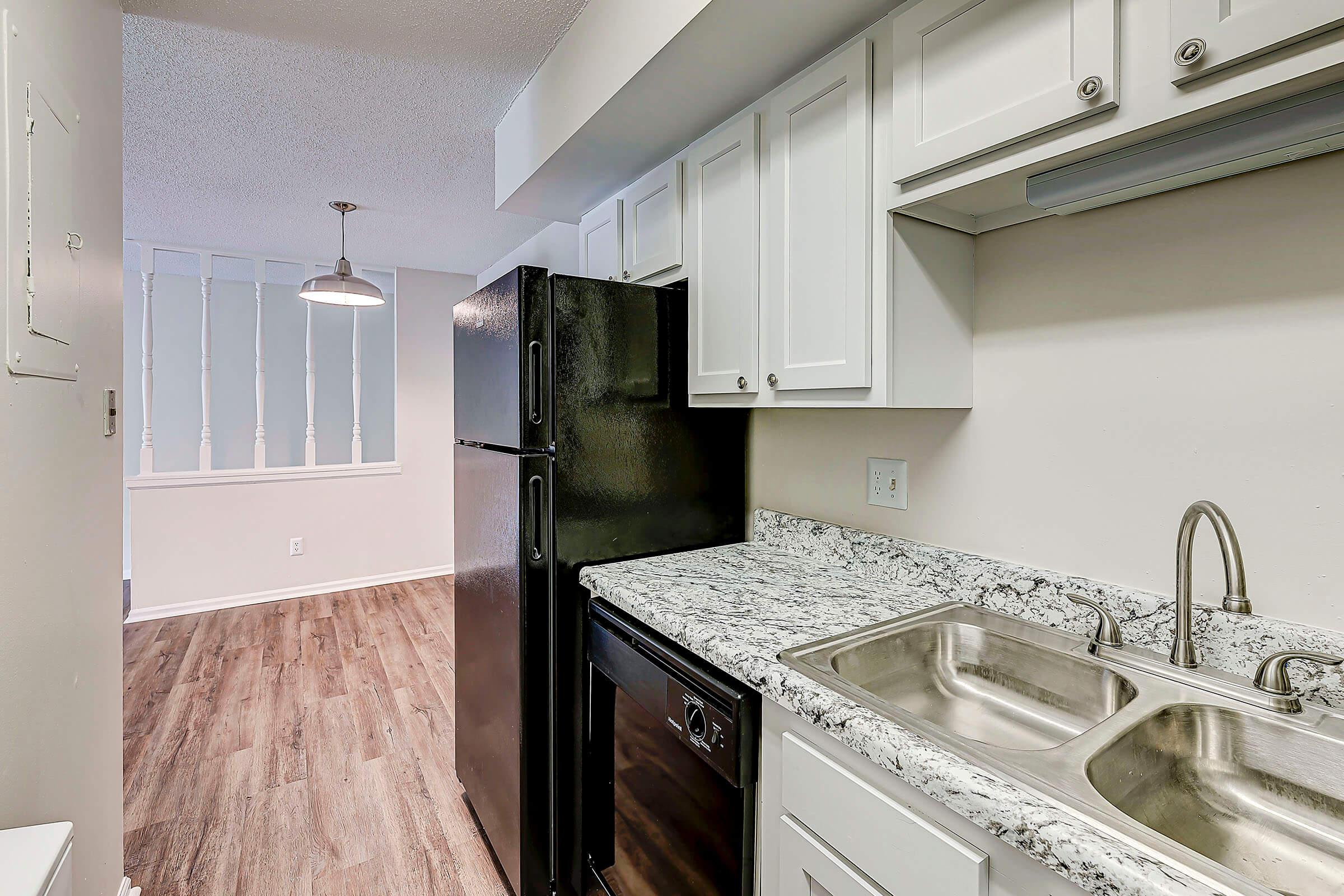 a kitchen with a sink and a mirror