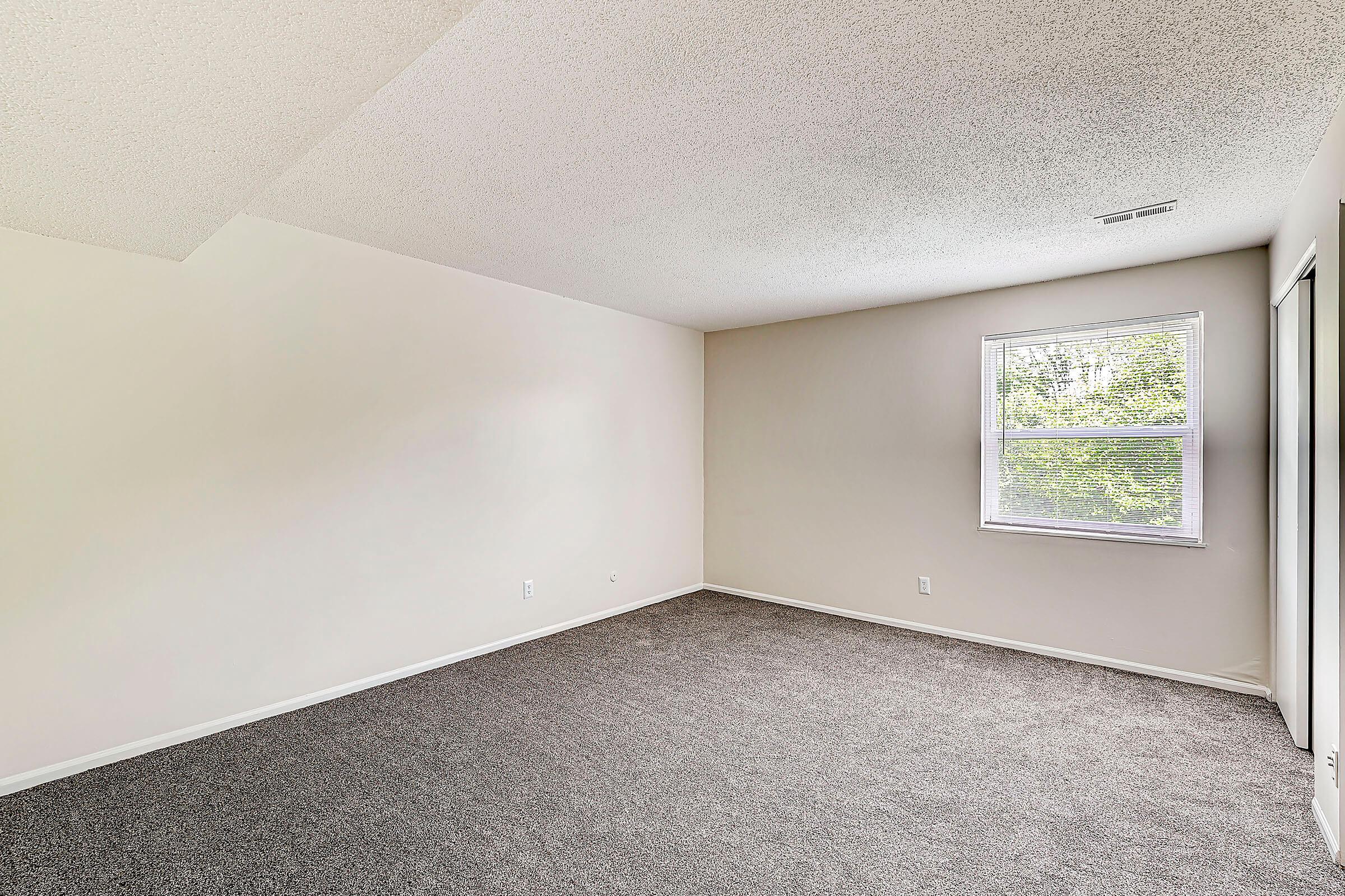 a bedroom with a large window