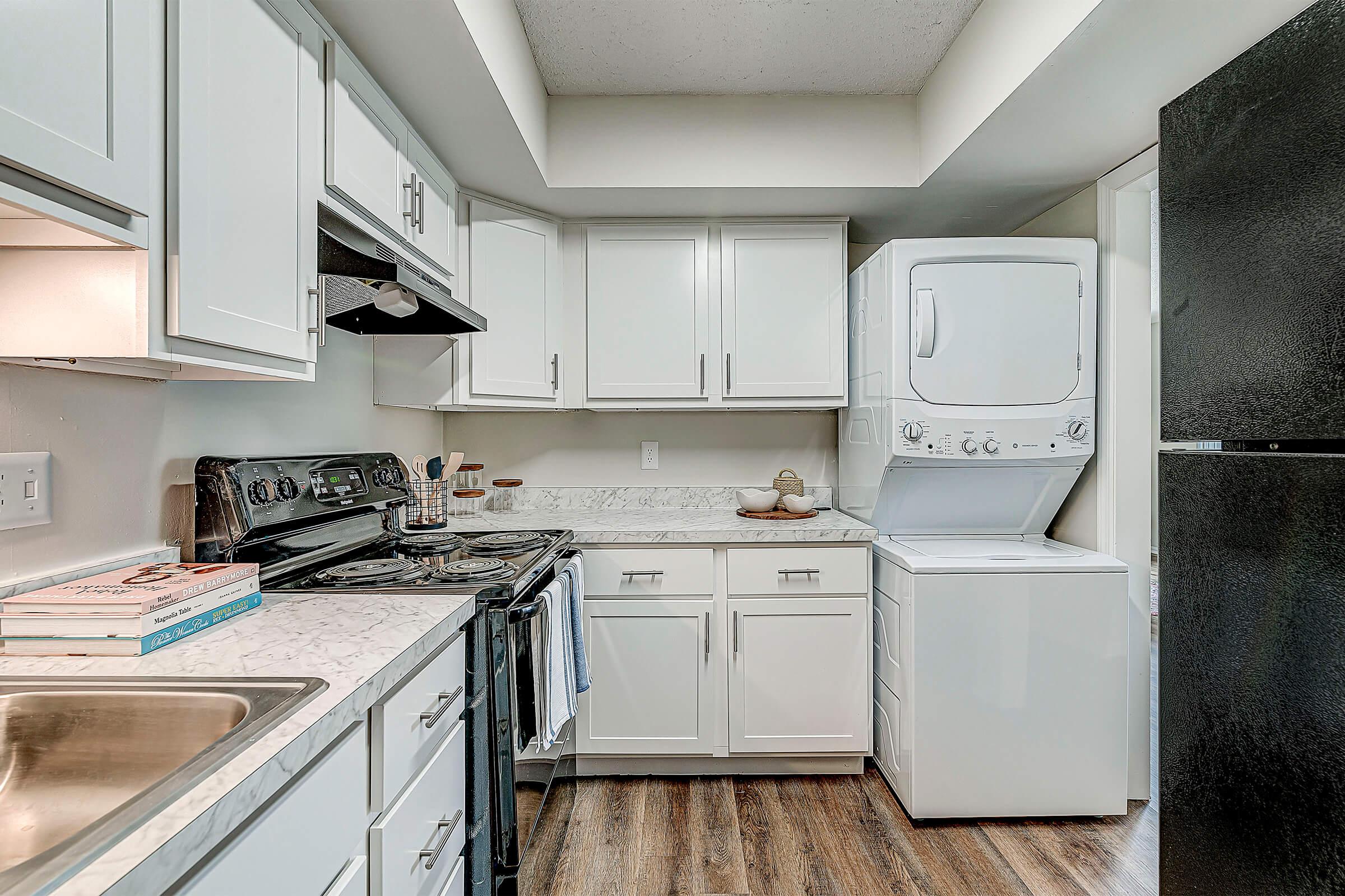 a kitchen with a stove sink and refrigerator