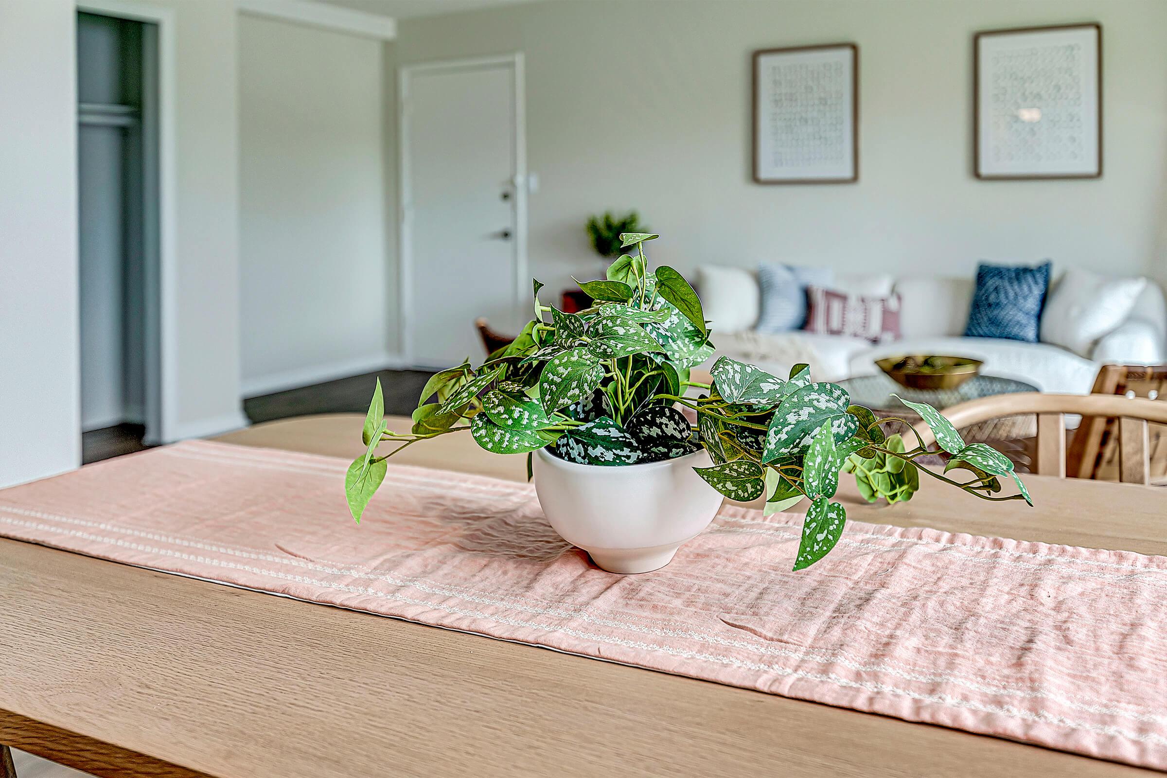 a room filled with furniture and vase of flowers on a table