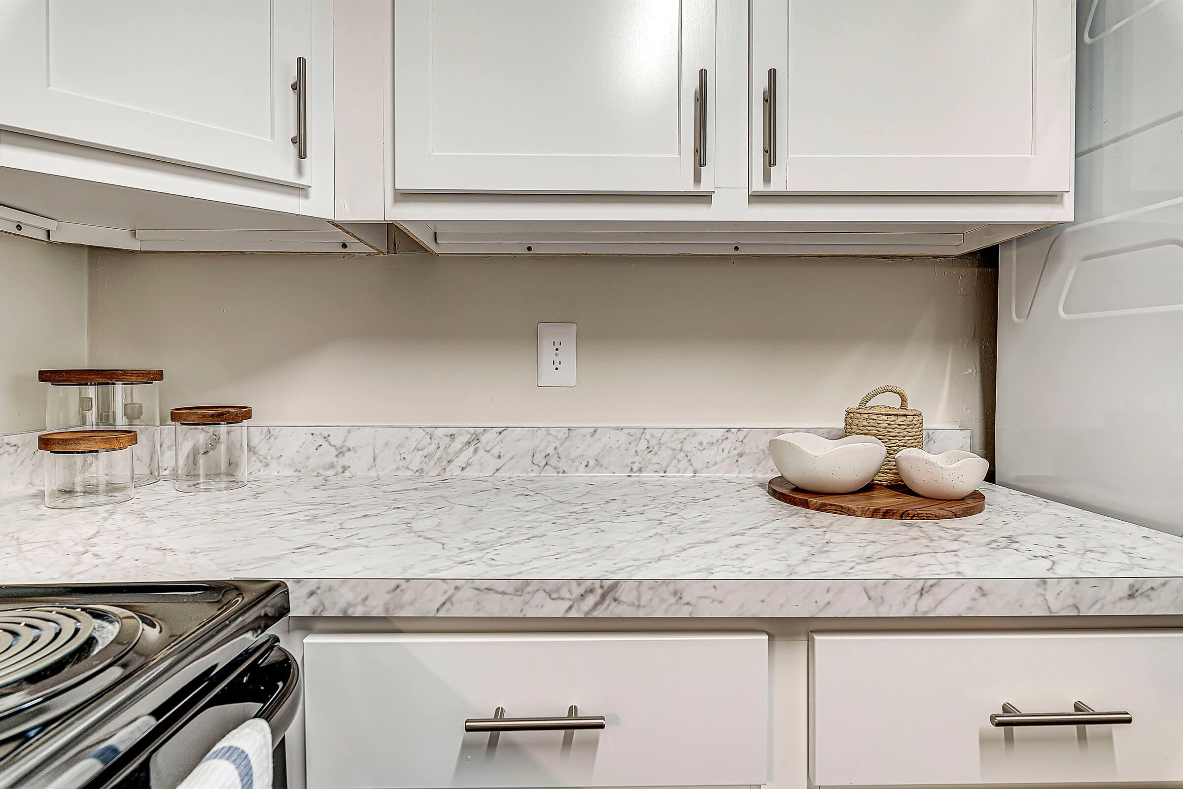 a stove top oven sitting inside of a kitchen