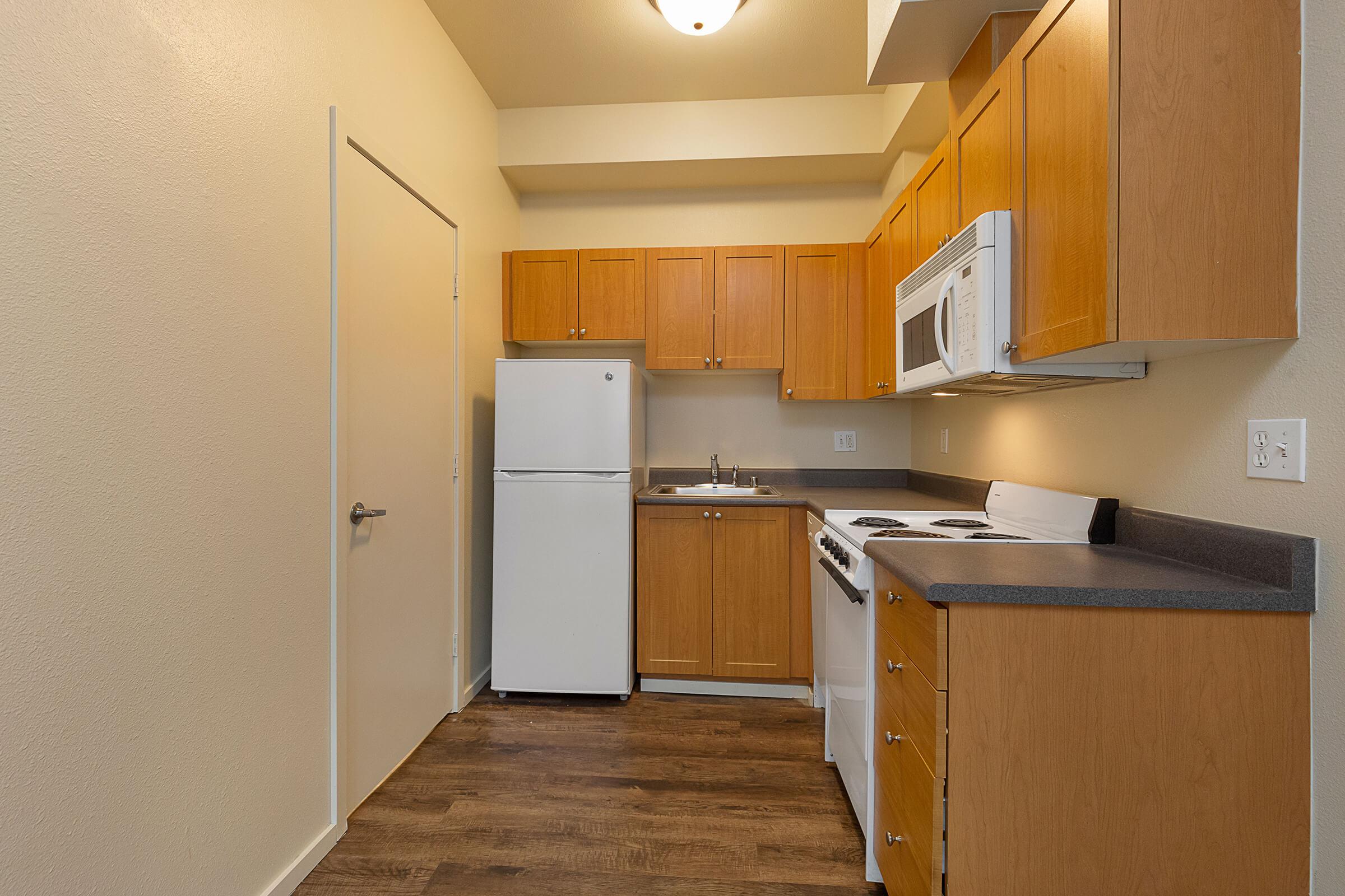a kitchen with a stove and a refrigerator