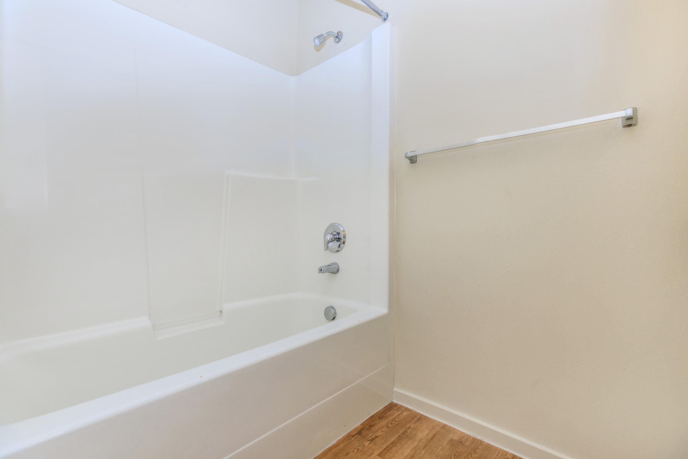 a large tub next to a shower