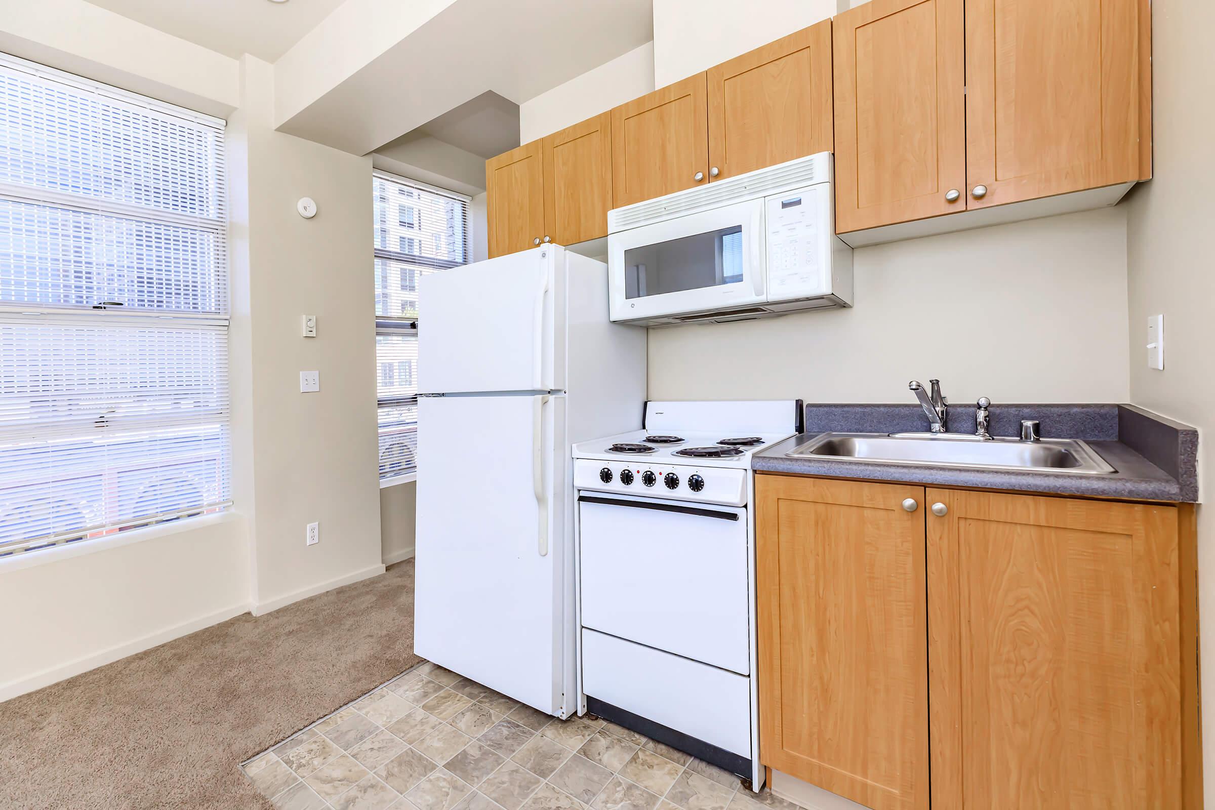 a kitchen with a stove sink and refrigerator