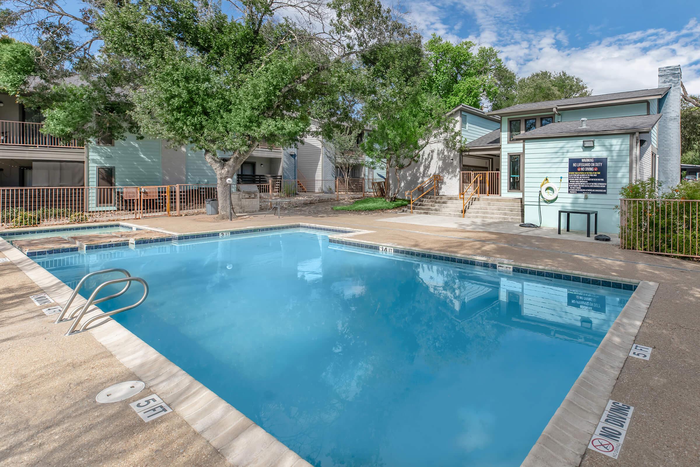 a house with a pool outside of a building