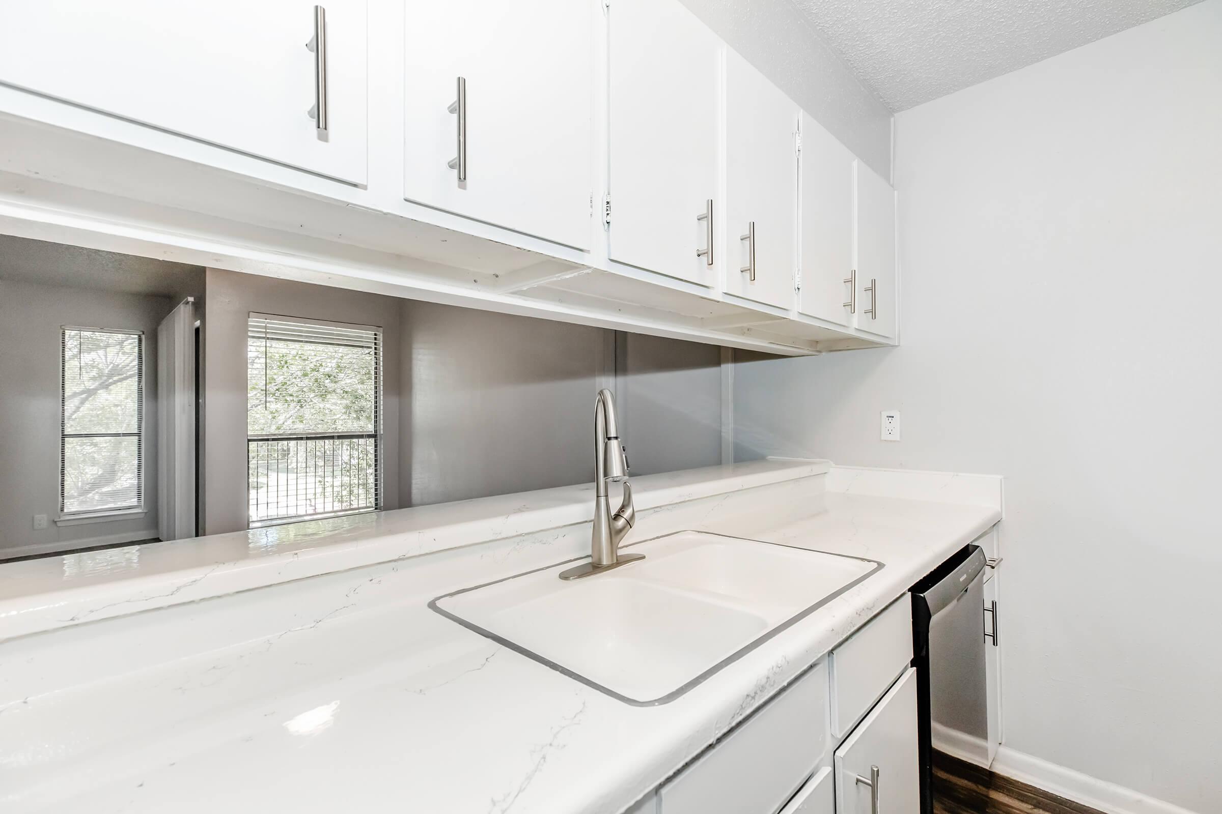 a kitchen with a sink and a window