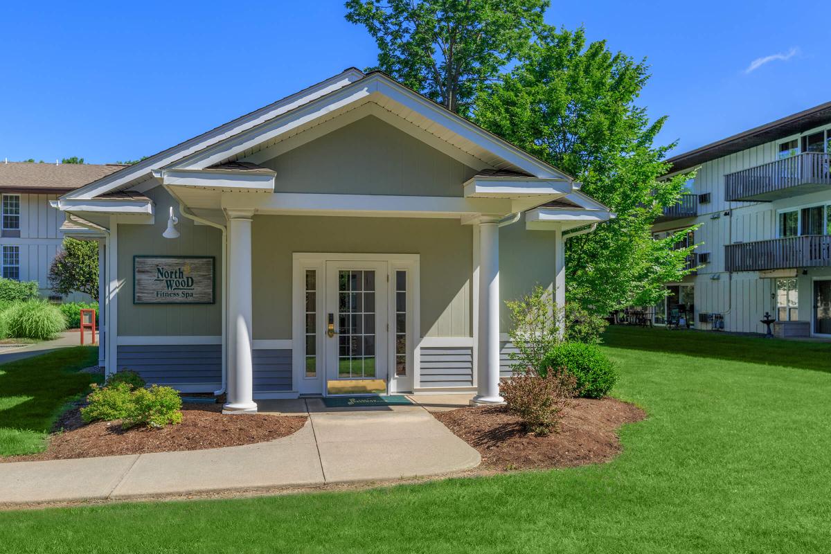 a house with a lawn in front of a building