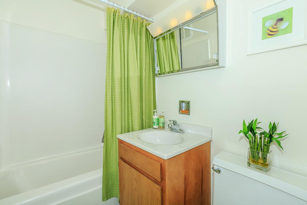 a white tub sitting next to a sink