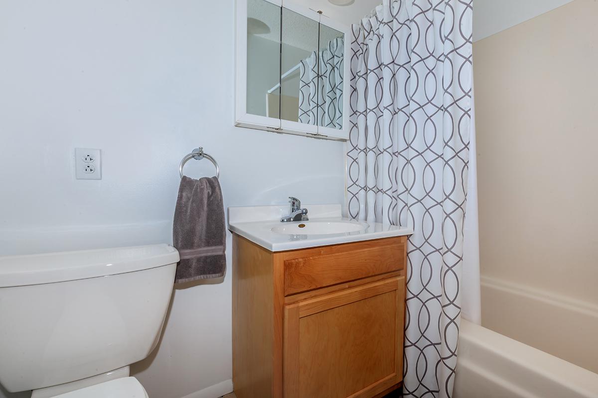 a white tub sitting next to a sink