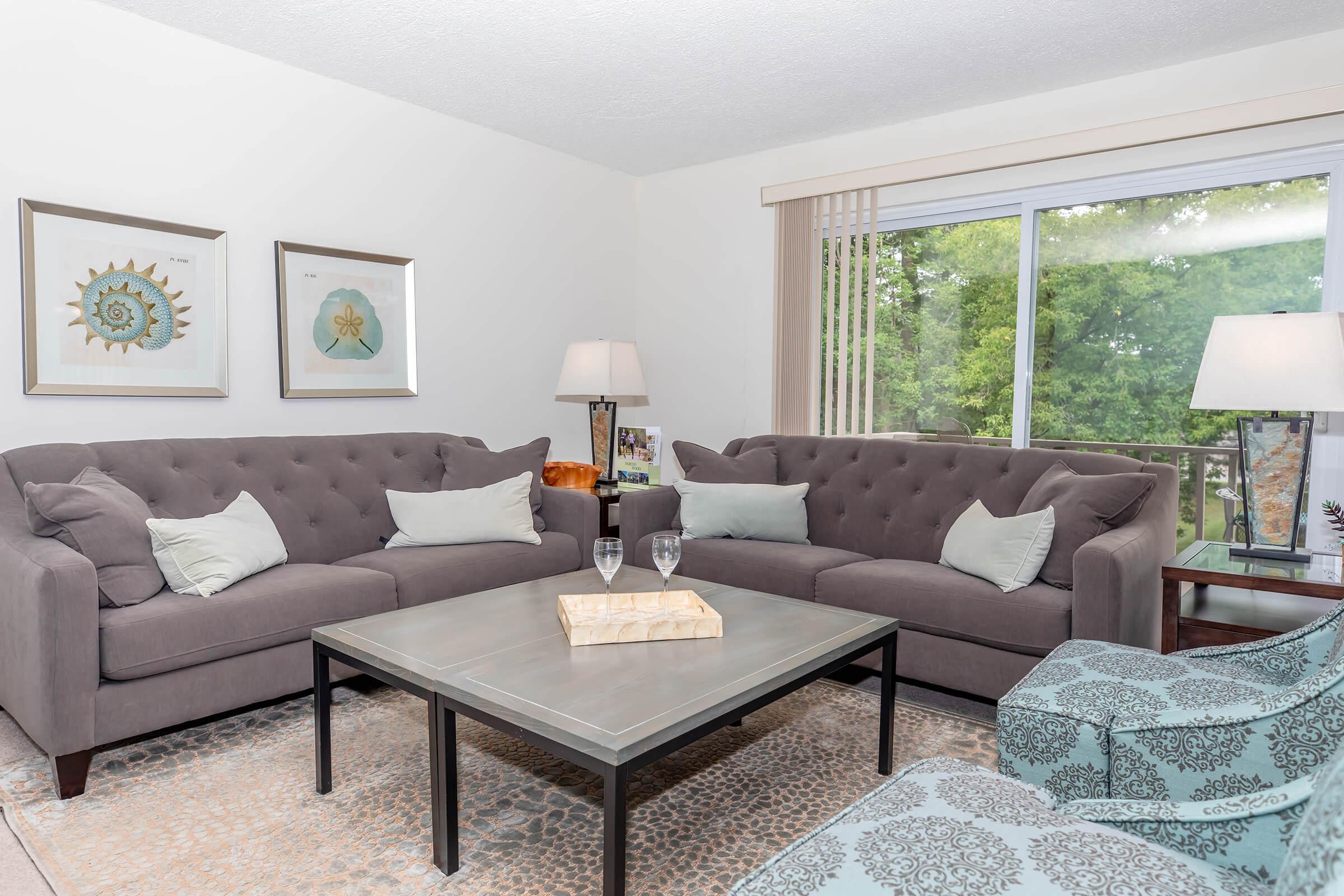 a living room filled with furniture and a flat screen tv