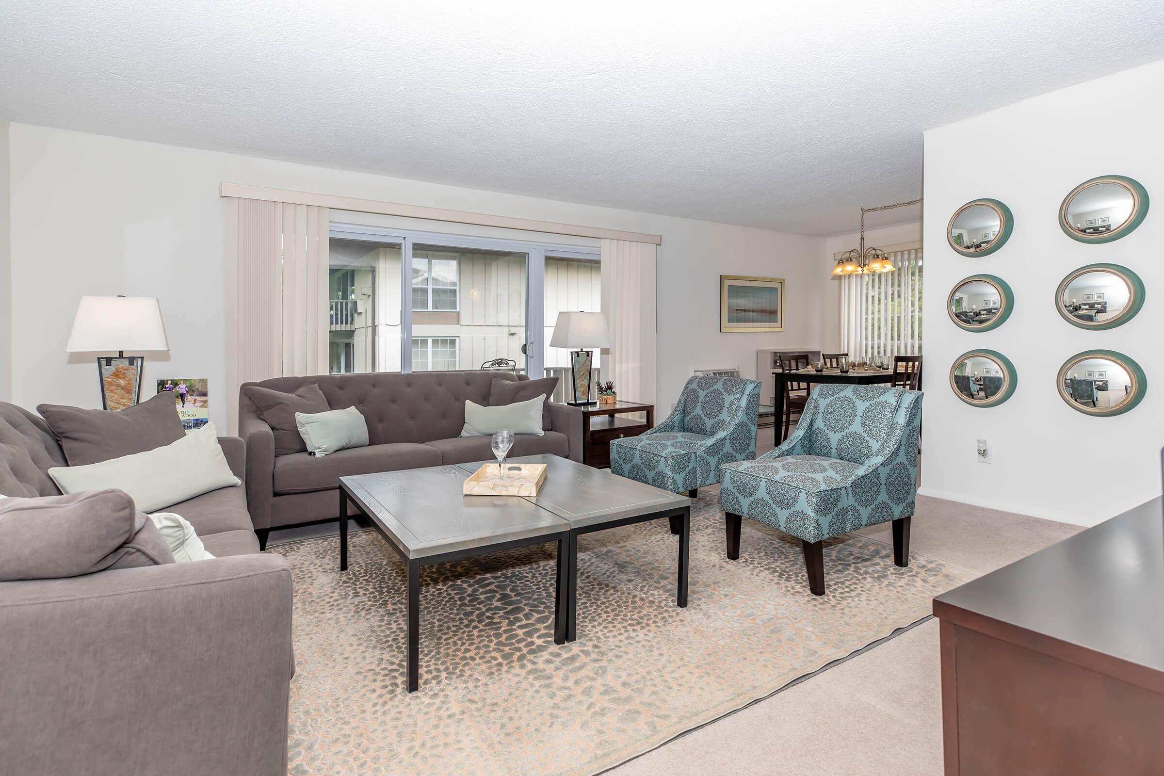 a living room filled with furniture and a large window